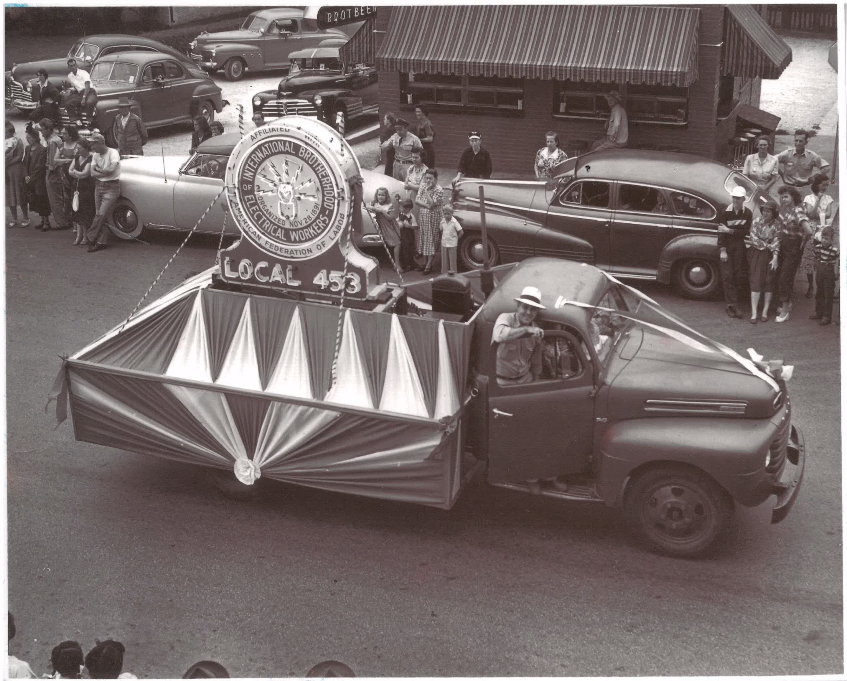 Vintage black-and-white photo of an IBEW Local 453 parade vehicle