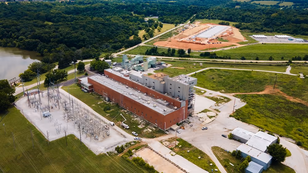 Aerial view of a completed building with landscaped grounds
