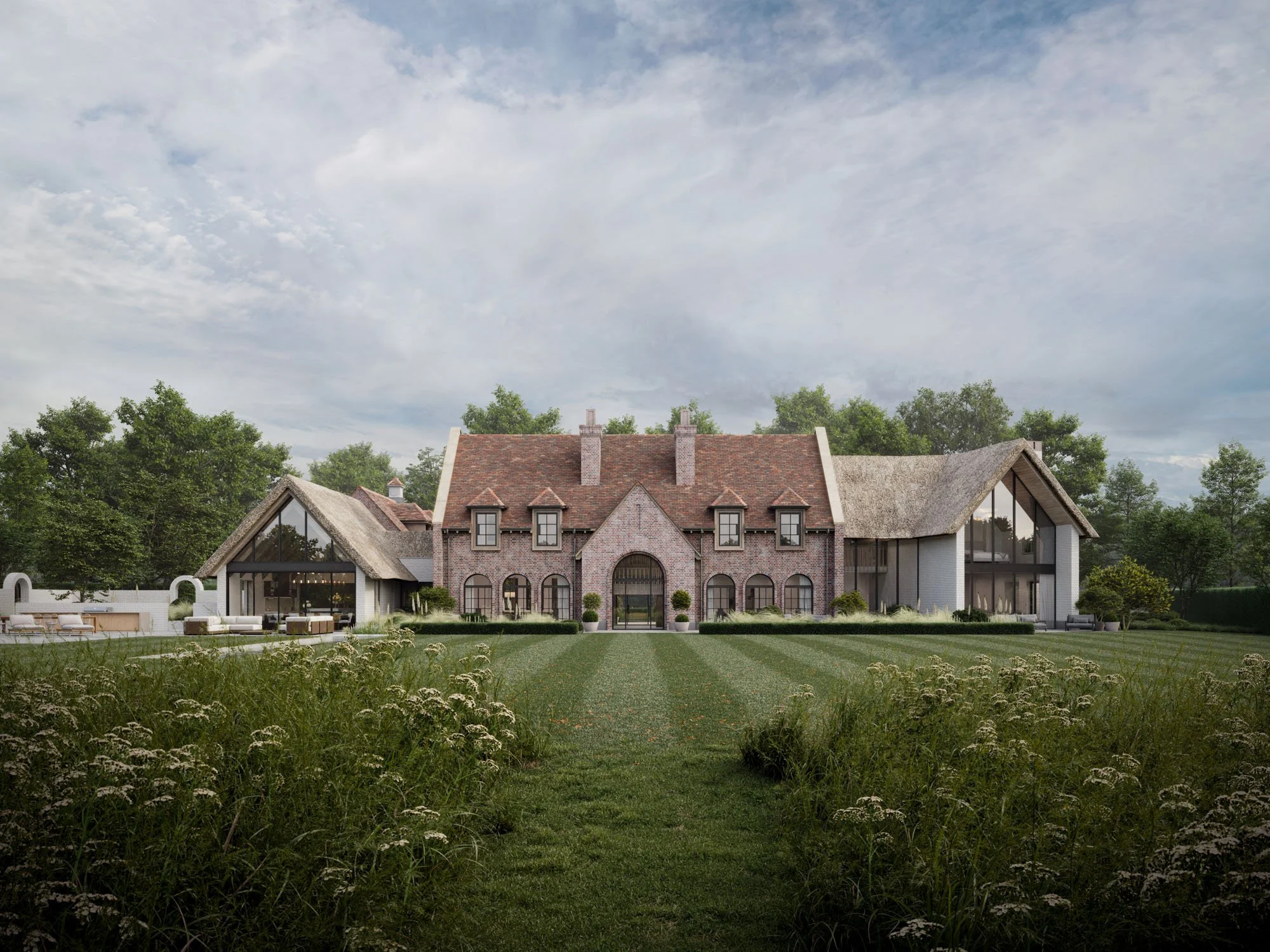 Large brick house with pitched roof and large glass walls, surrounded by green lawn and trees.