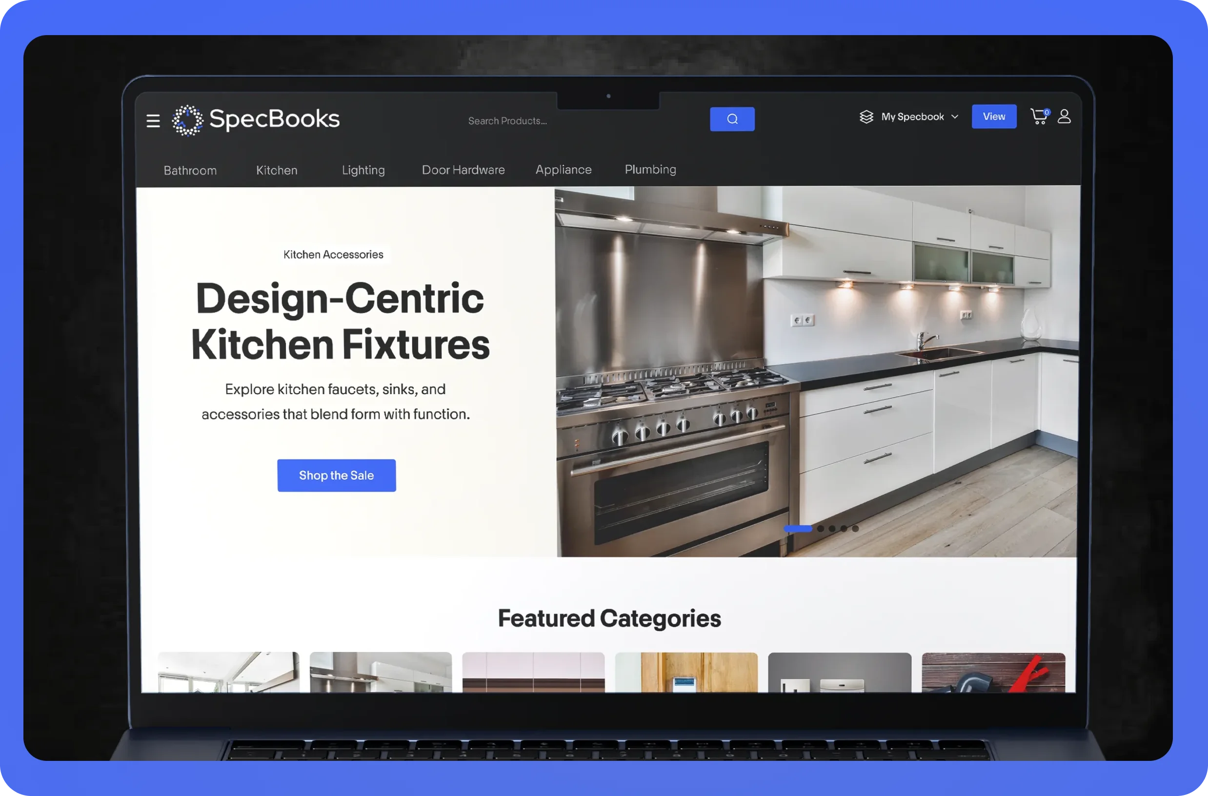 Laptop screen showing SpecBooks website with design-centric kitchen fixtures and kitchen photo.