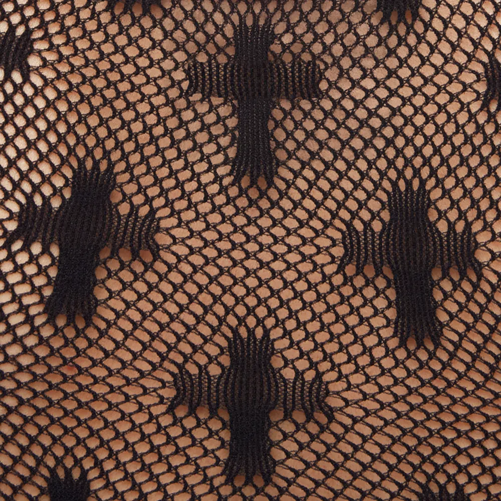 Close up of fishnet texture with crosses of Minga london fabric