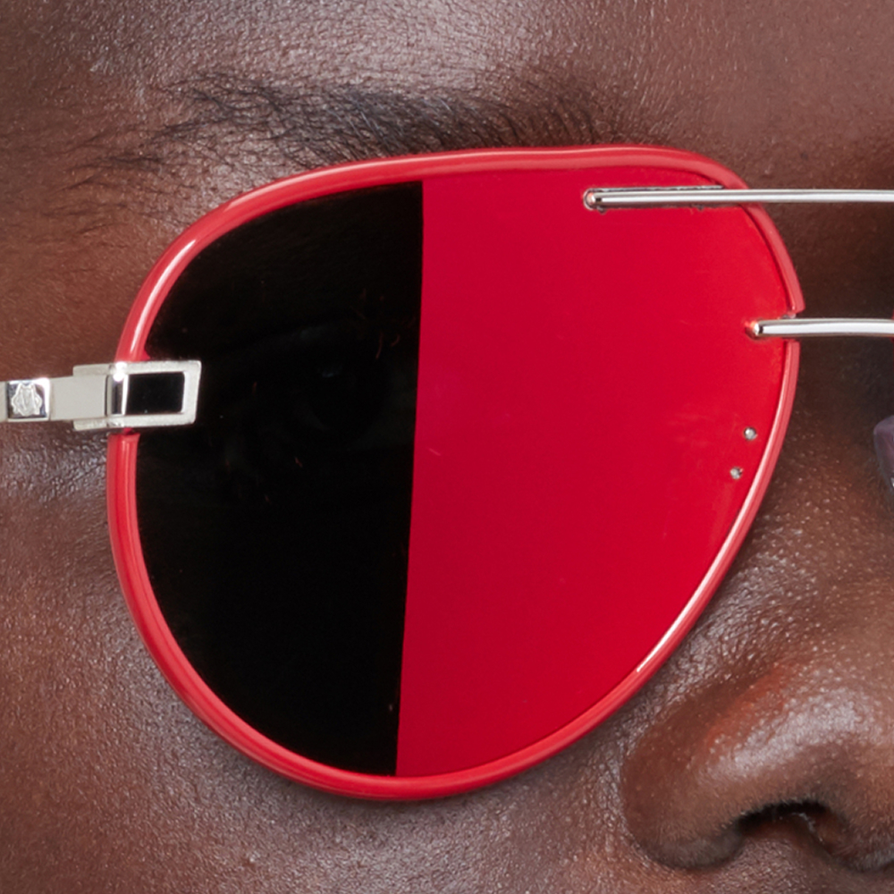 Closeup eCommerce photography of red Rimowa sunglasses
