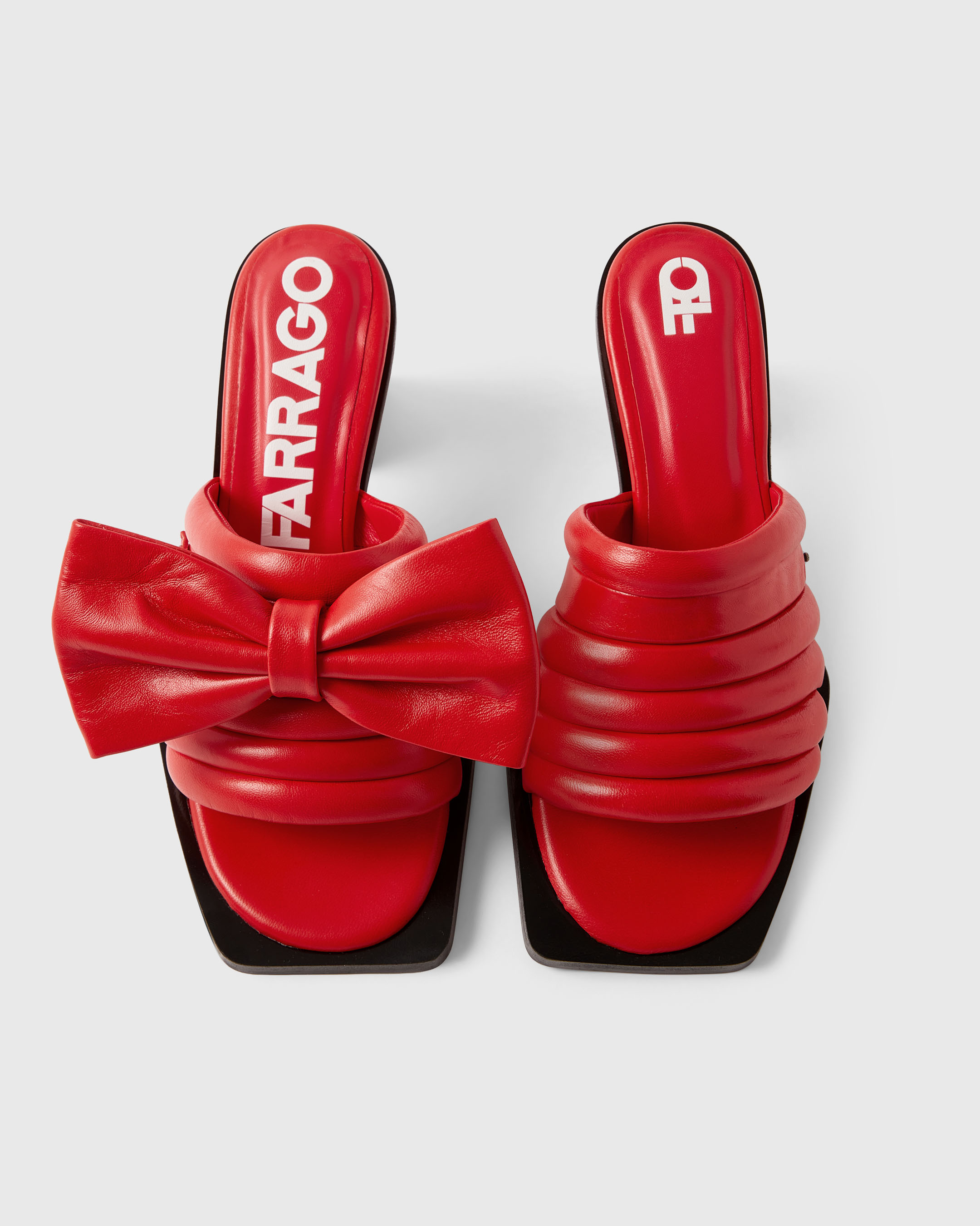 Product photography of a red pair of Farrago mules