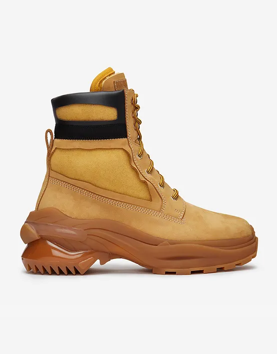 Tan suede men's boot with thick brown sole and black padded ankle collar.