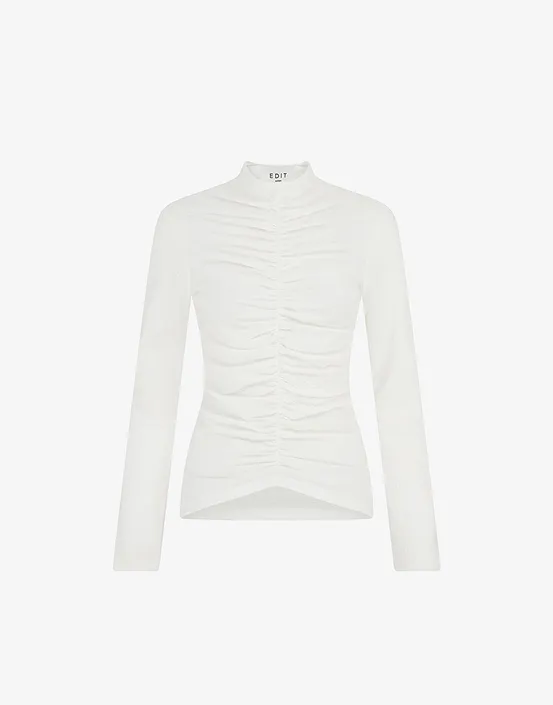 White long-sleeve women's top with ruched detailing and a high neckline.