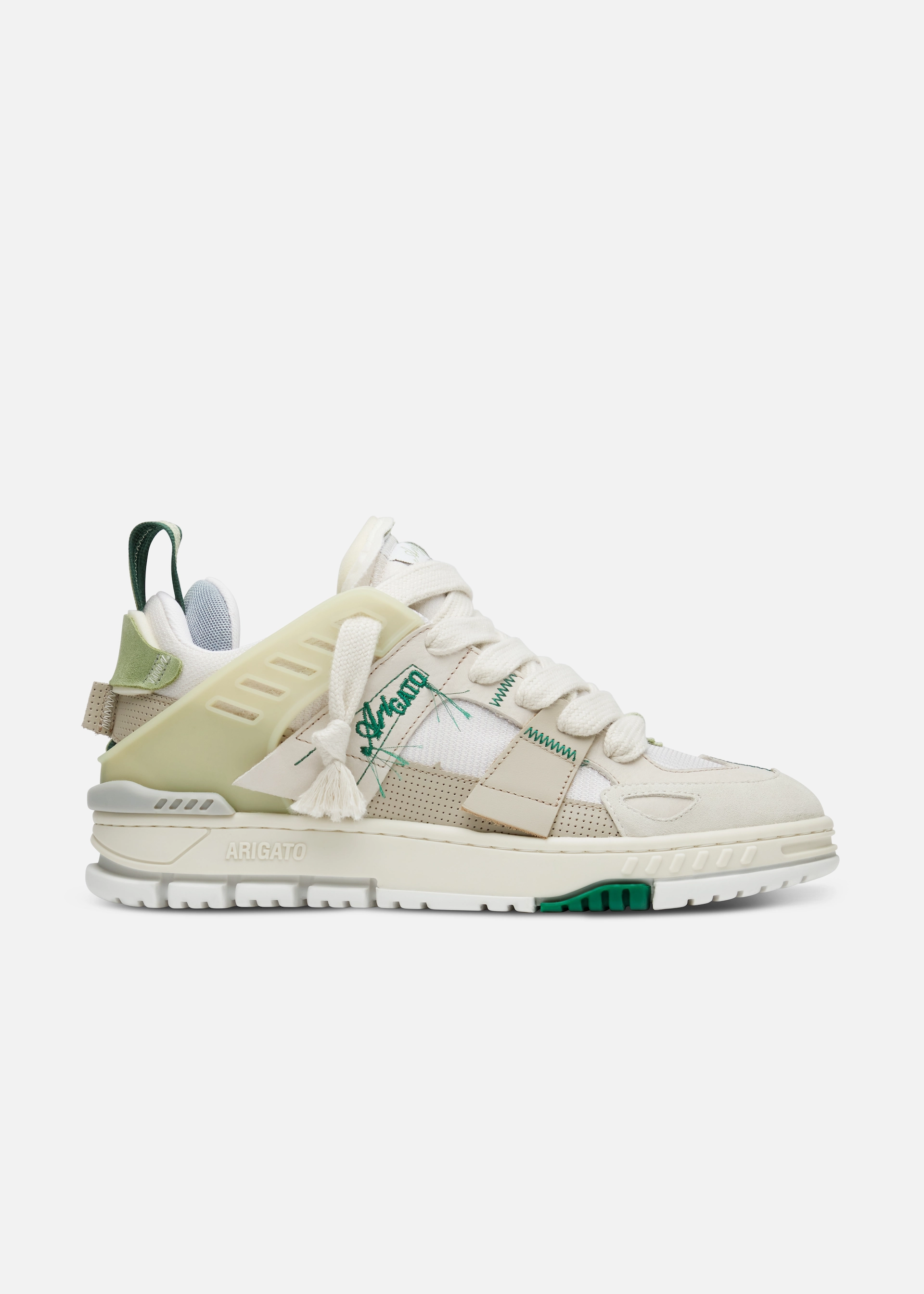 Cream Axel Arigato sneaker with green accents, thick sole, knit and suede panels, and ARIGATO branding.