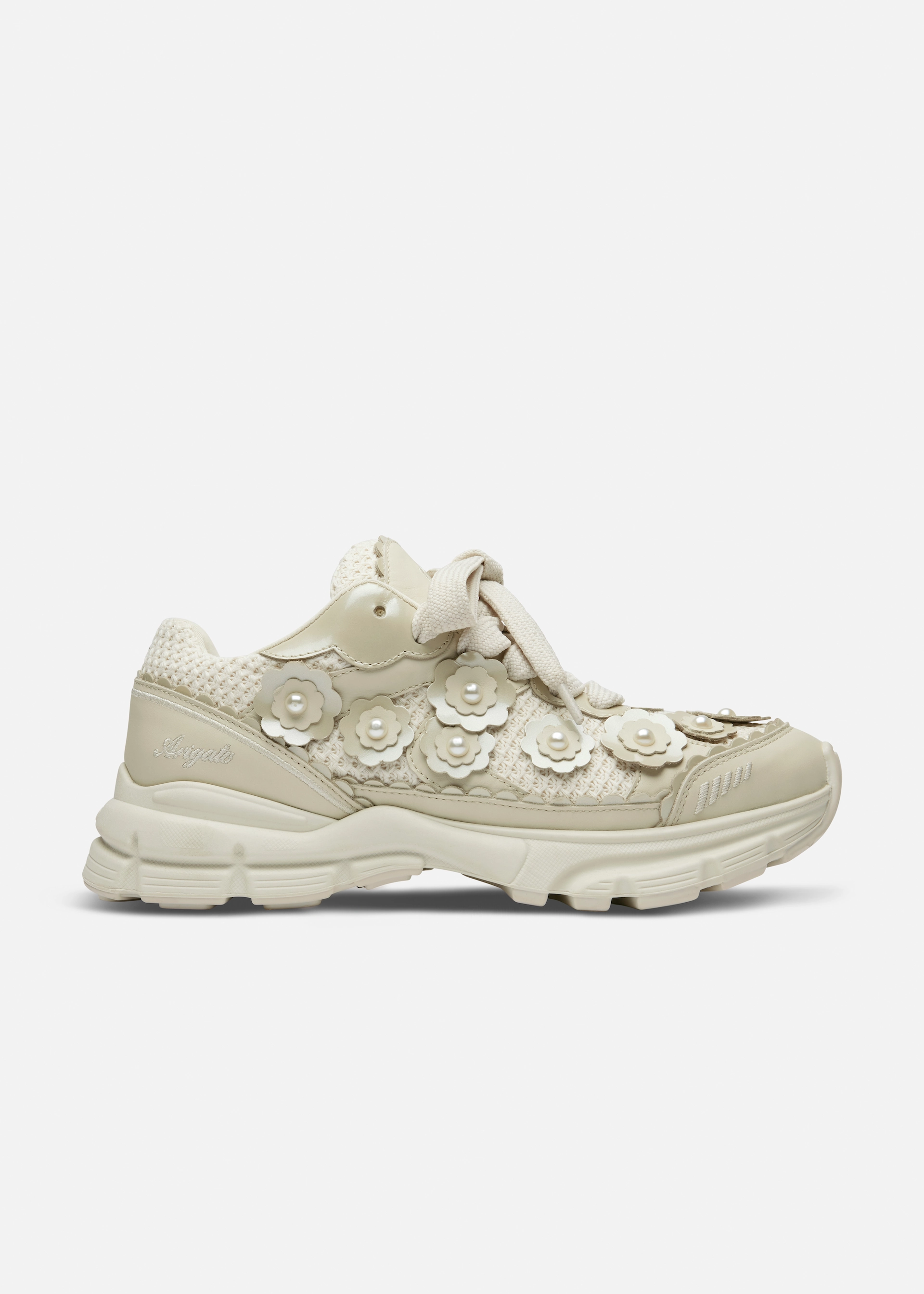 Beige Axel Arigato sneaker with floral appliqués featuring pearl centers and knitted fabric panels.
