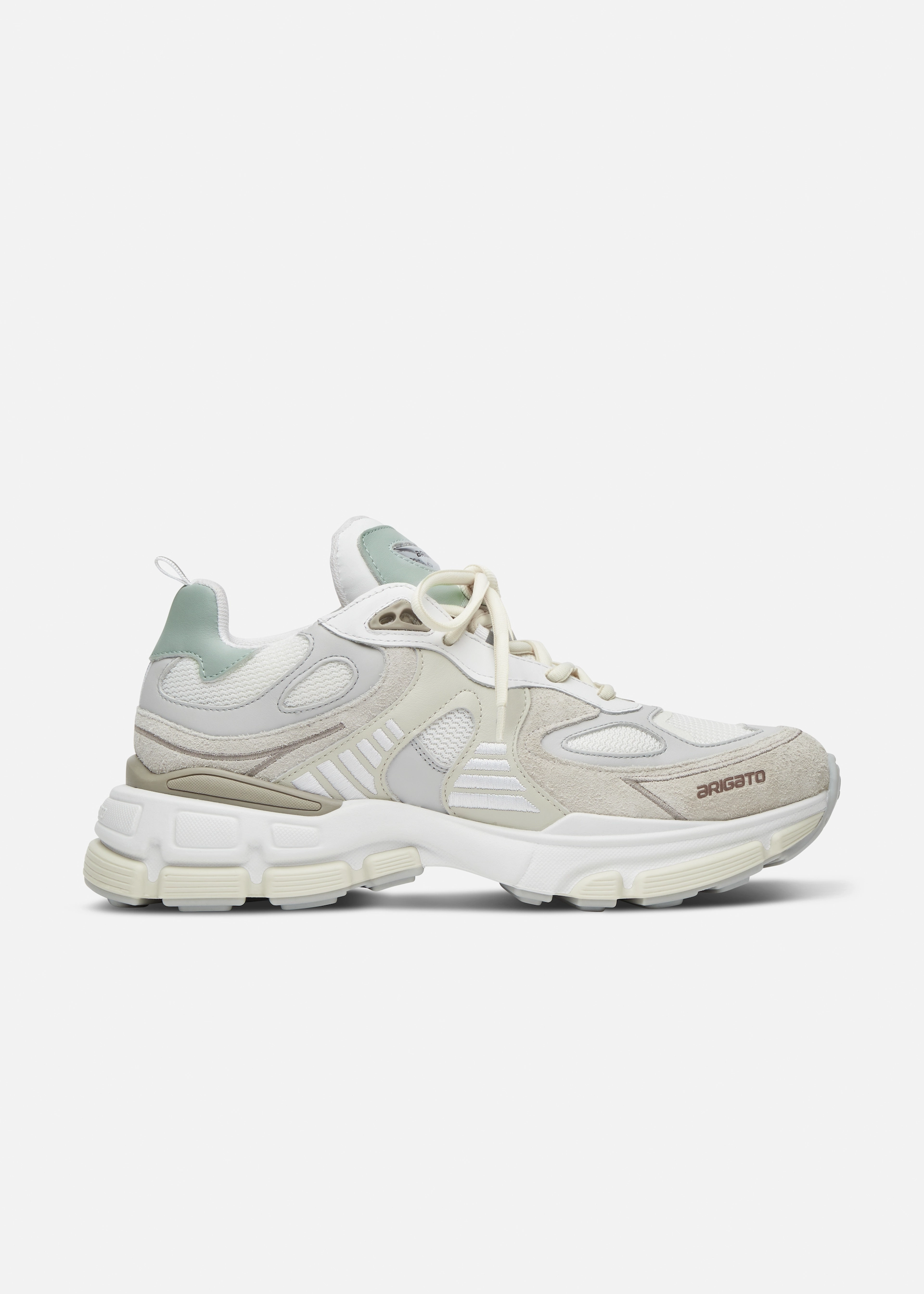 Side view of a white and beige sneaker with light green accents and 'arigato' text near the toe.