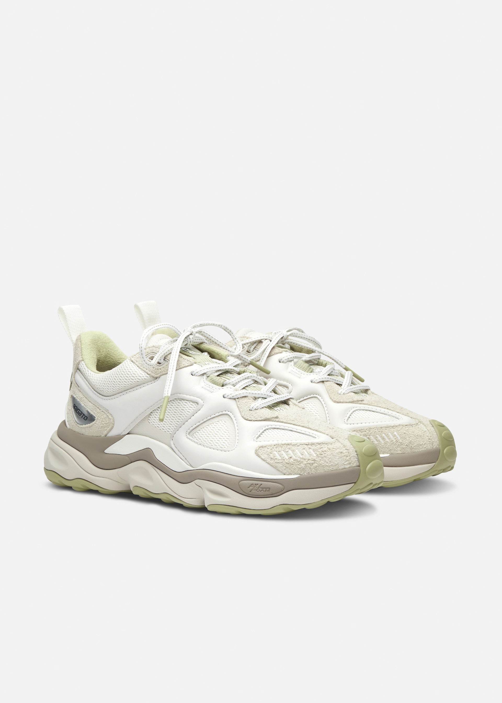 Pair of stylish cream and beige Axel Arigato athletic sneakers with textured and mesh details on a white background.