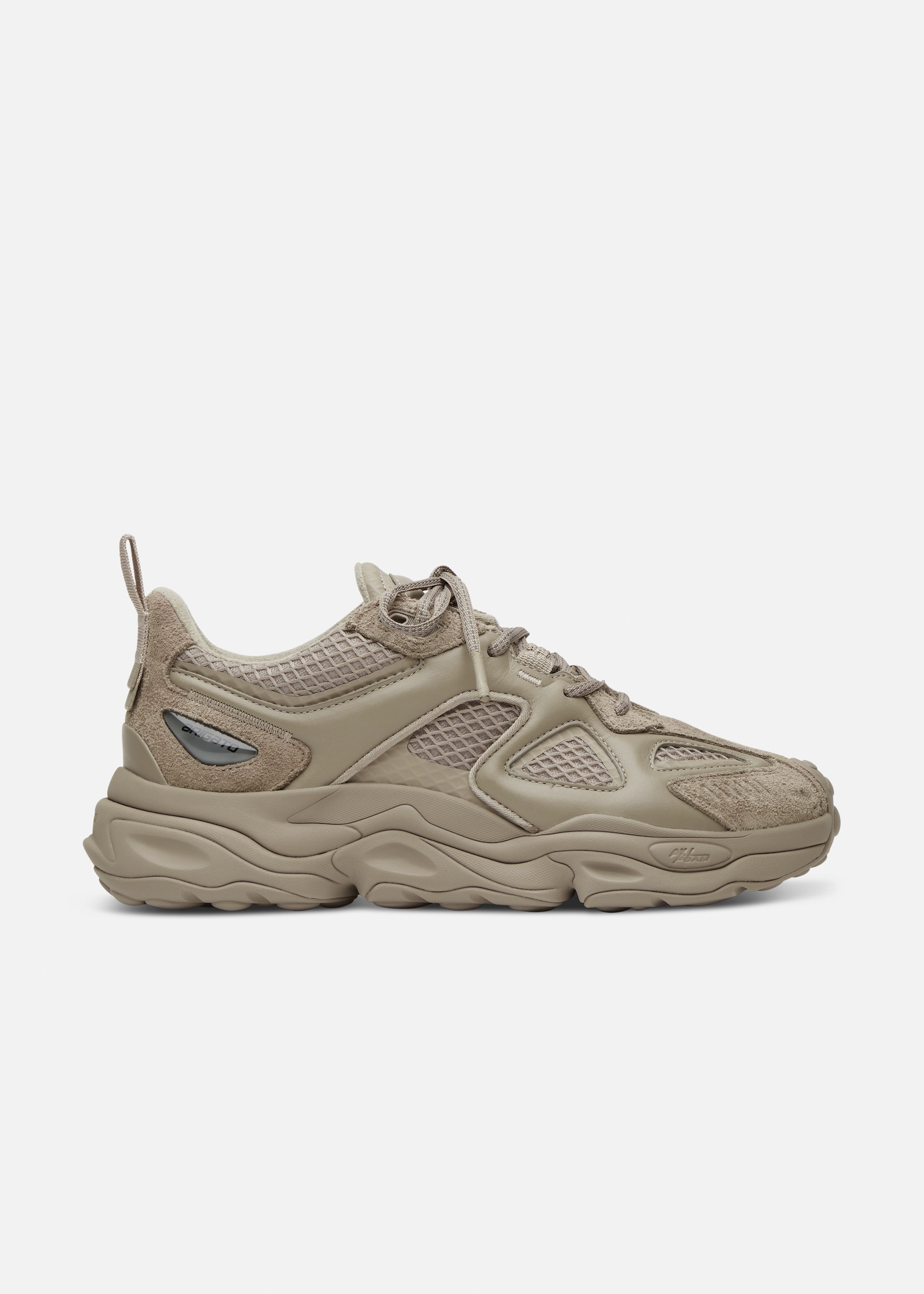 Side view of a beige Axel Arigato sporty sneaker with mesh, suede, and leather details and a wavy sole.