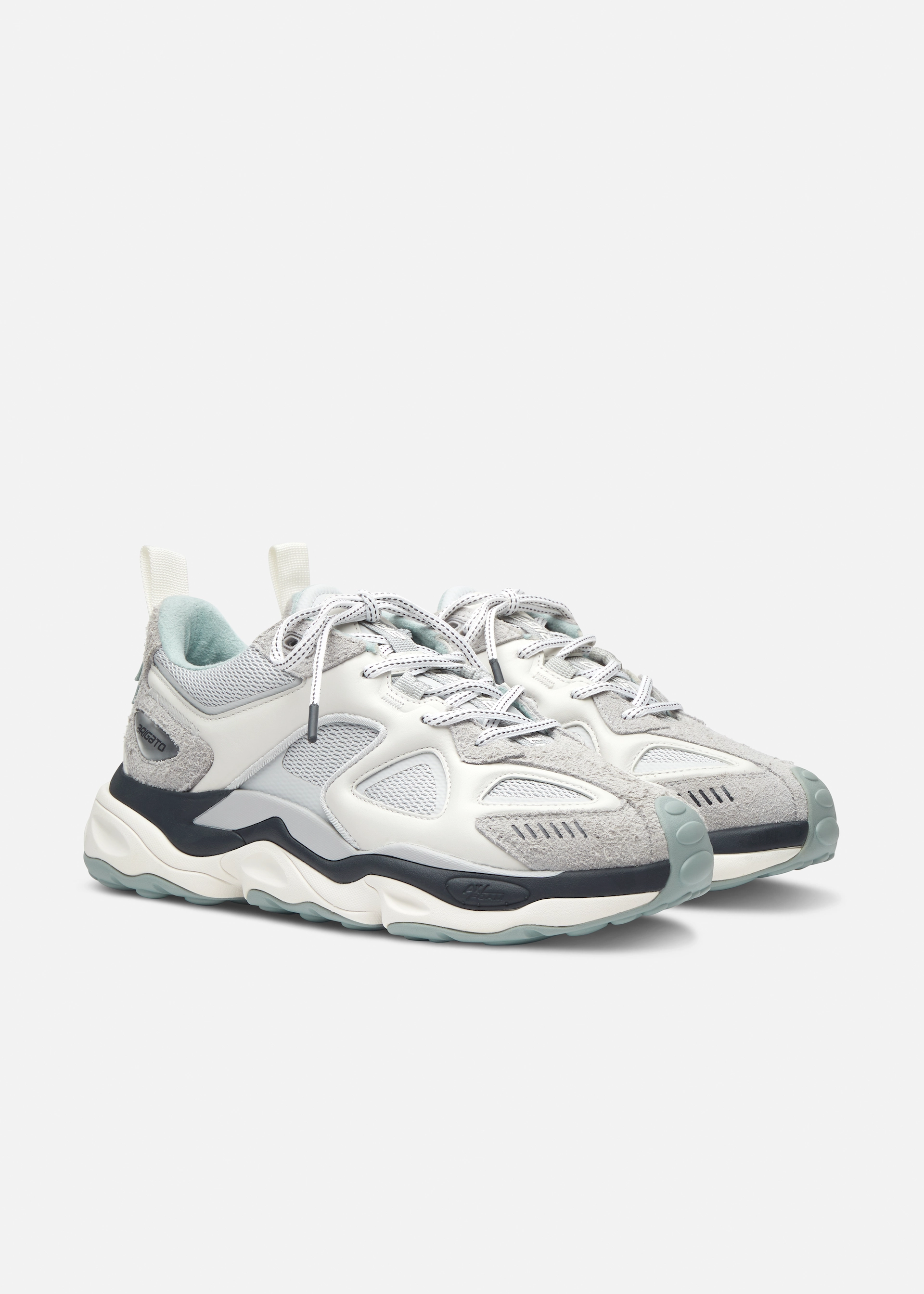 Pair of white and gray Axel Arigato athletic sneakers with black accents and textured soles.