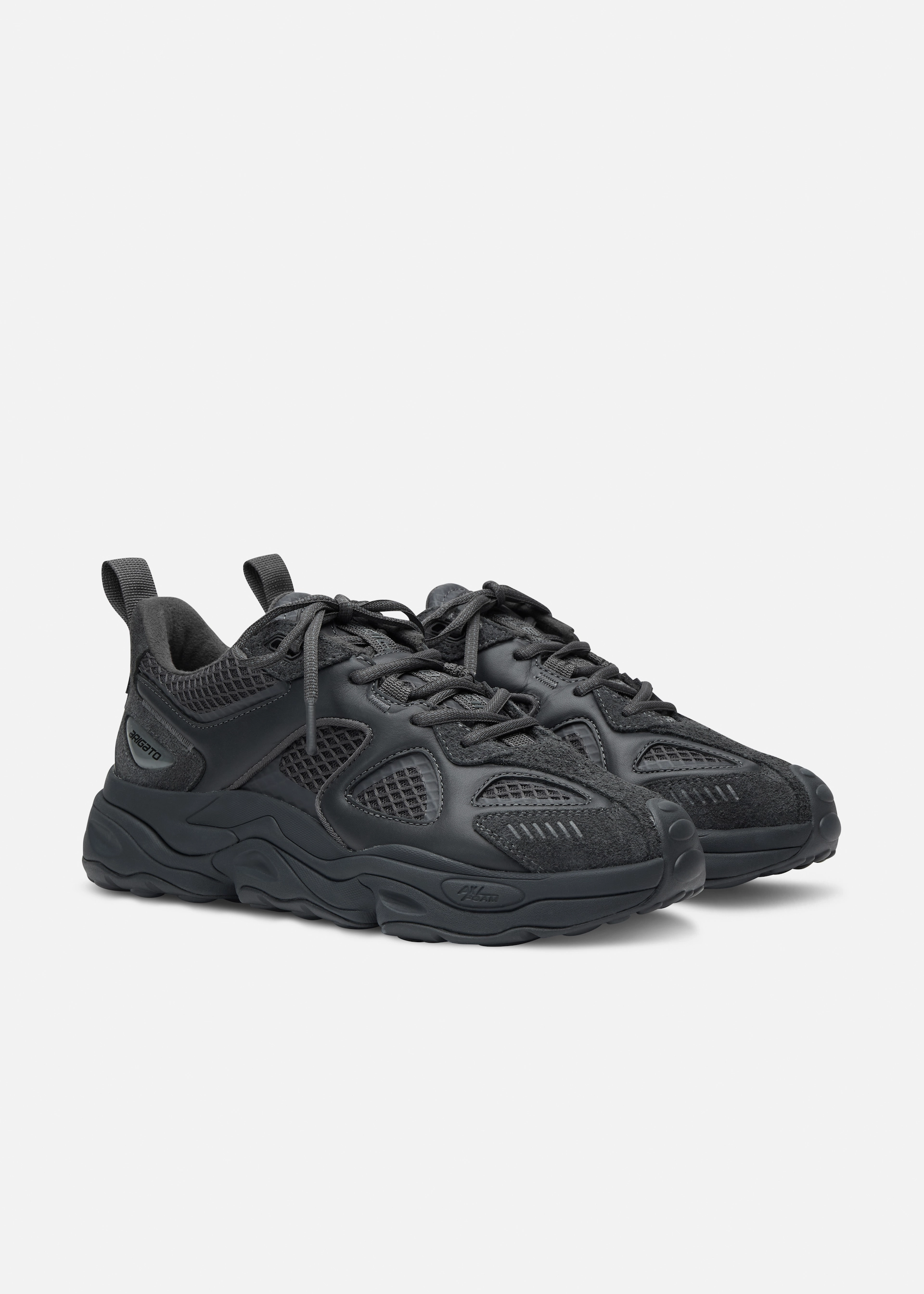Pair of dark gray Axel Arigato athletic sneakers with textured panels and thick rubber soles on a white background.
