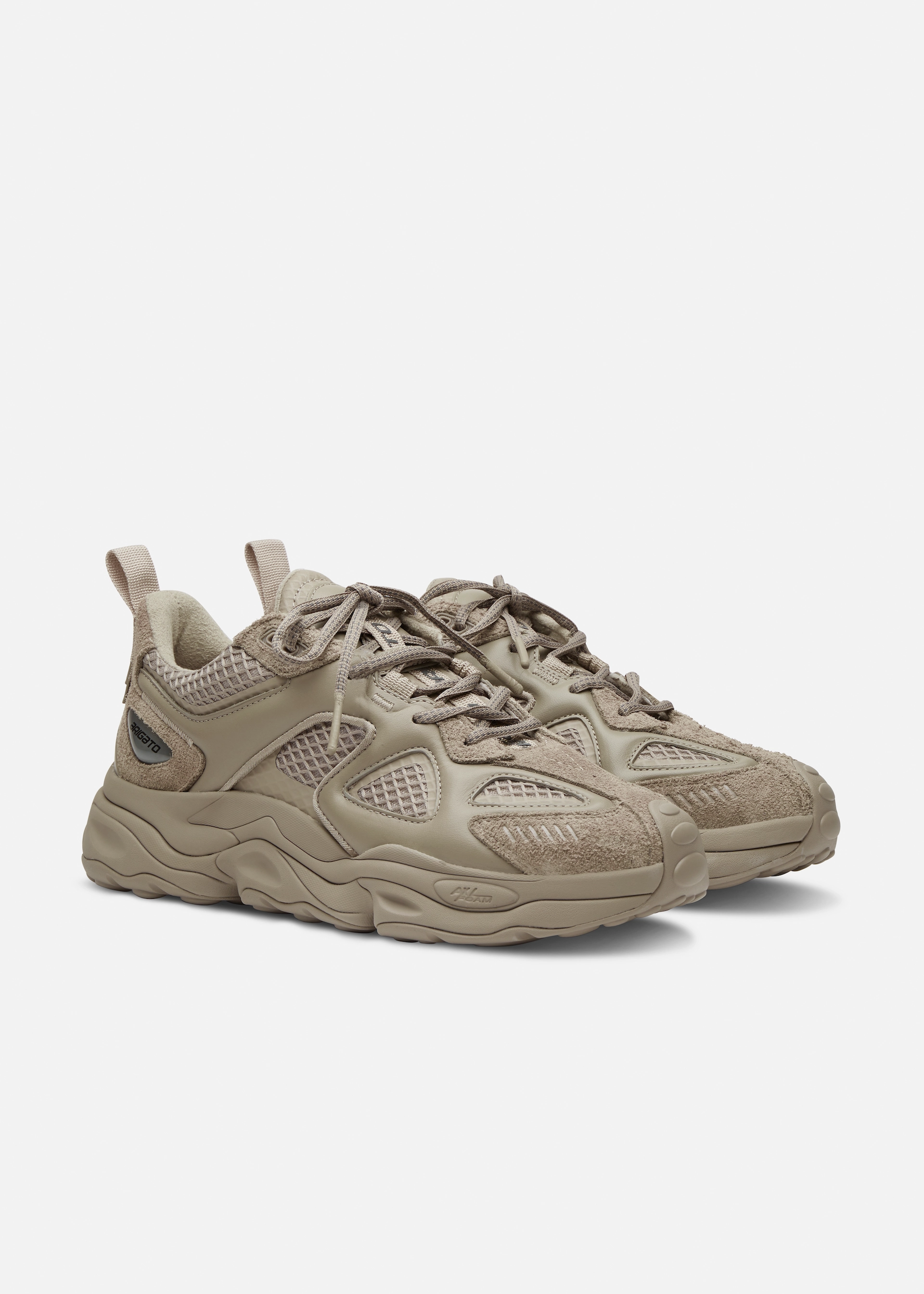 Pair of beige chunky Axel Arigato sneakers with suede, mesh panels, and thick sole on white background.