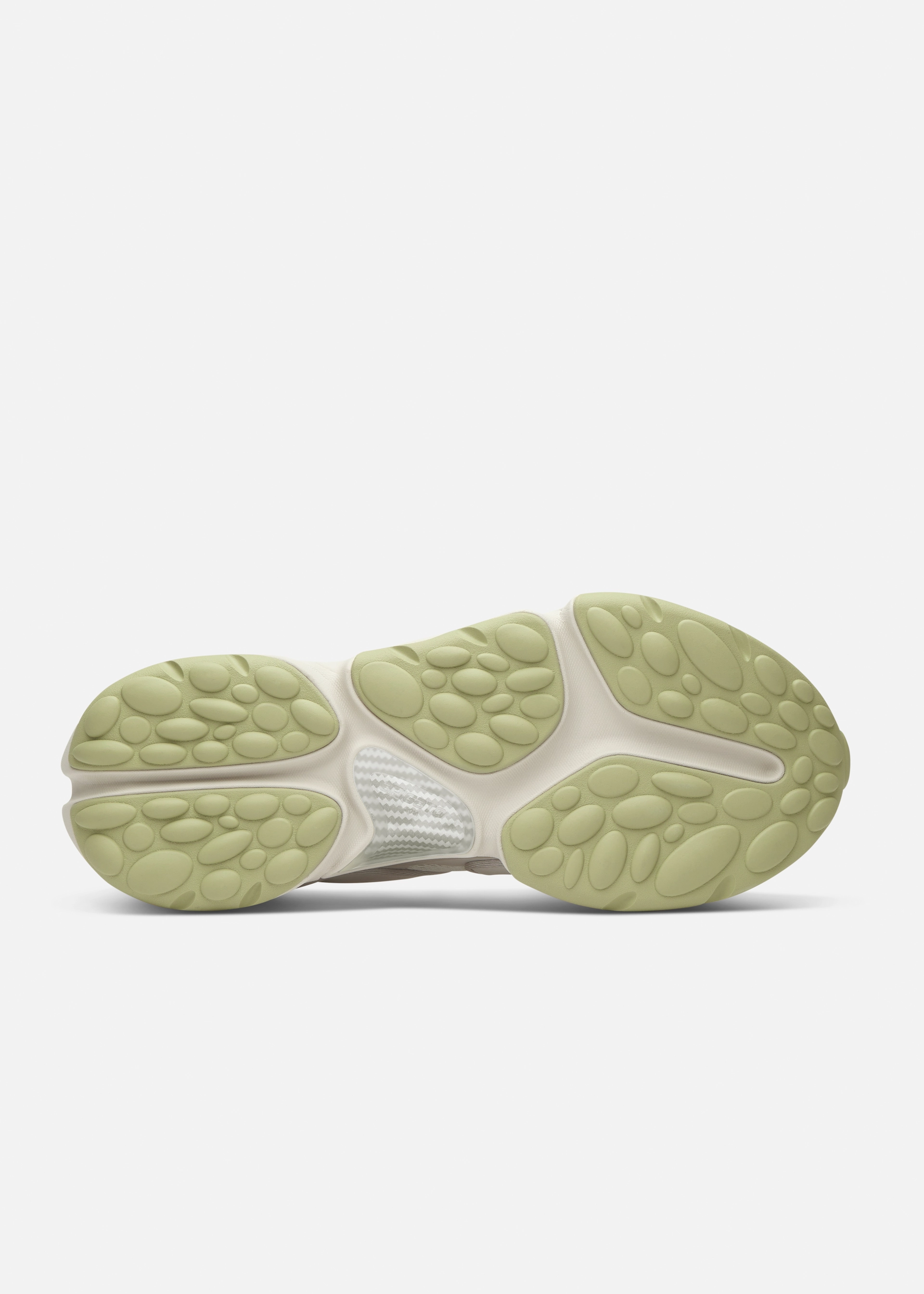 Sole of a light green and white Axel Arigato sneaker with pebble-patterned tread design.