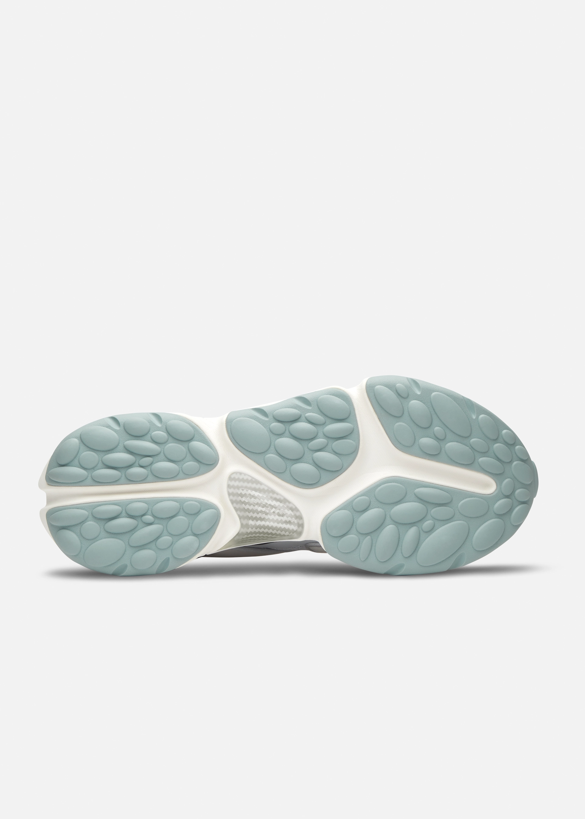 Sole of a Axel Arigato sneaker with light blue oval traction pads and white midsole viewed from below on white background.