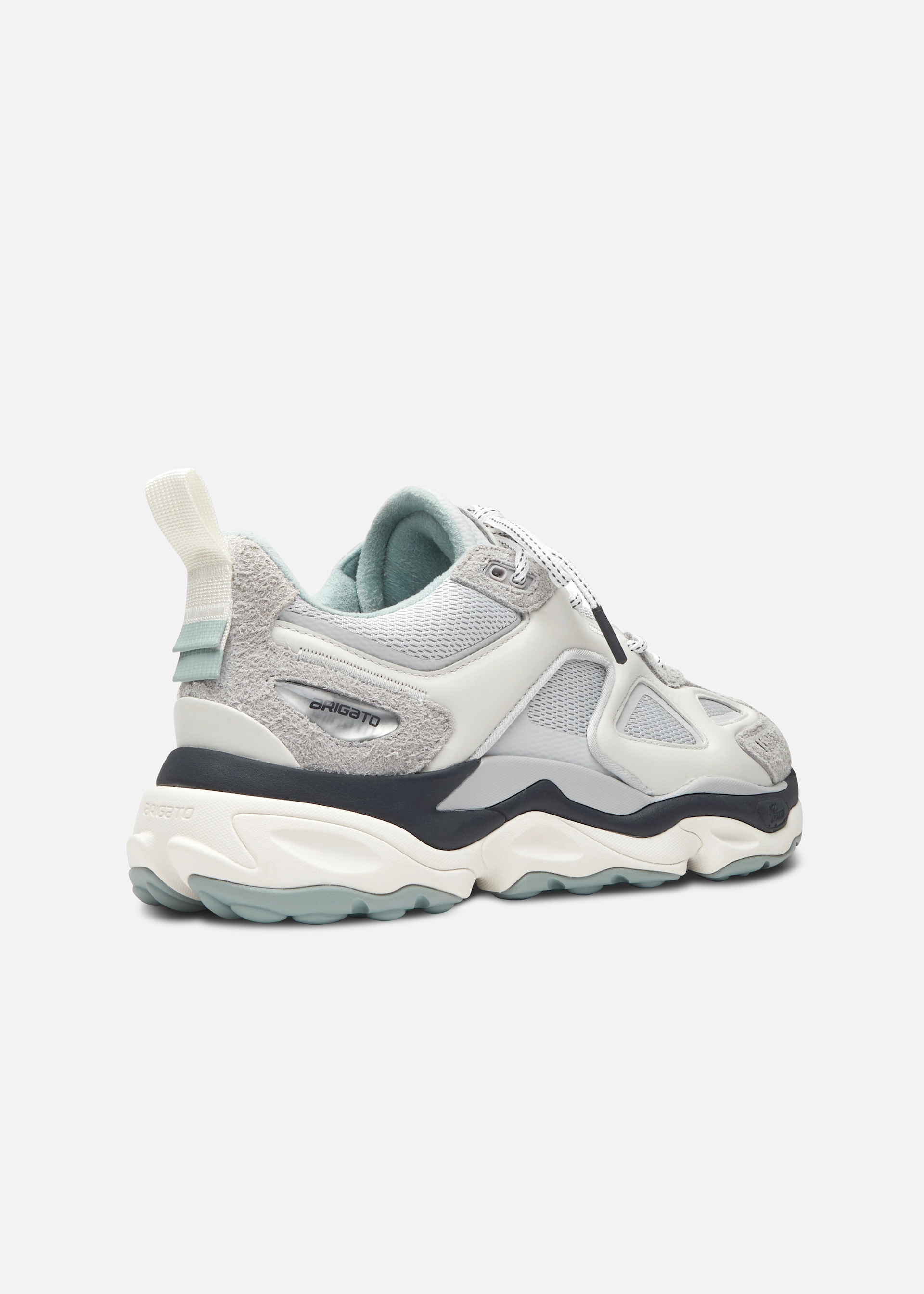 Side view of a gray and white Axel Arigato chunky sneaker with suede and mesh details and textured sole.