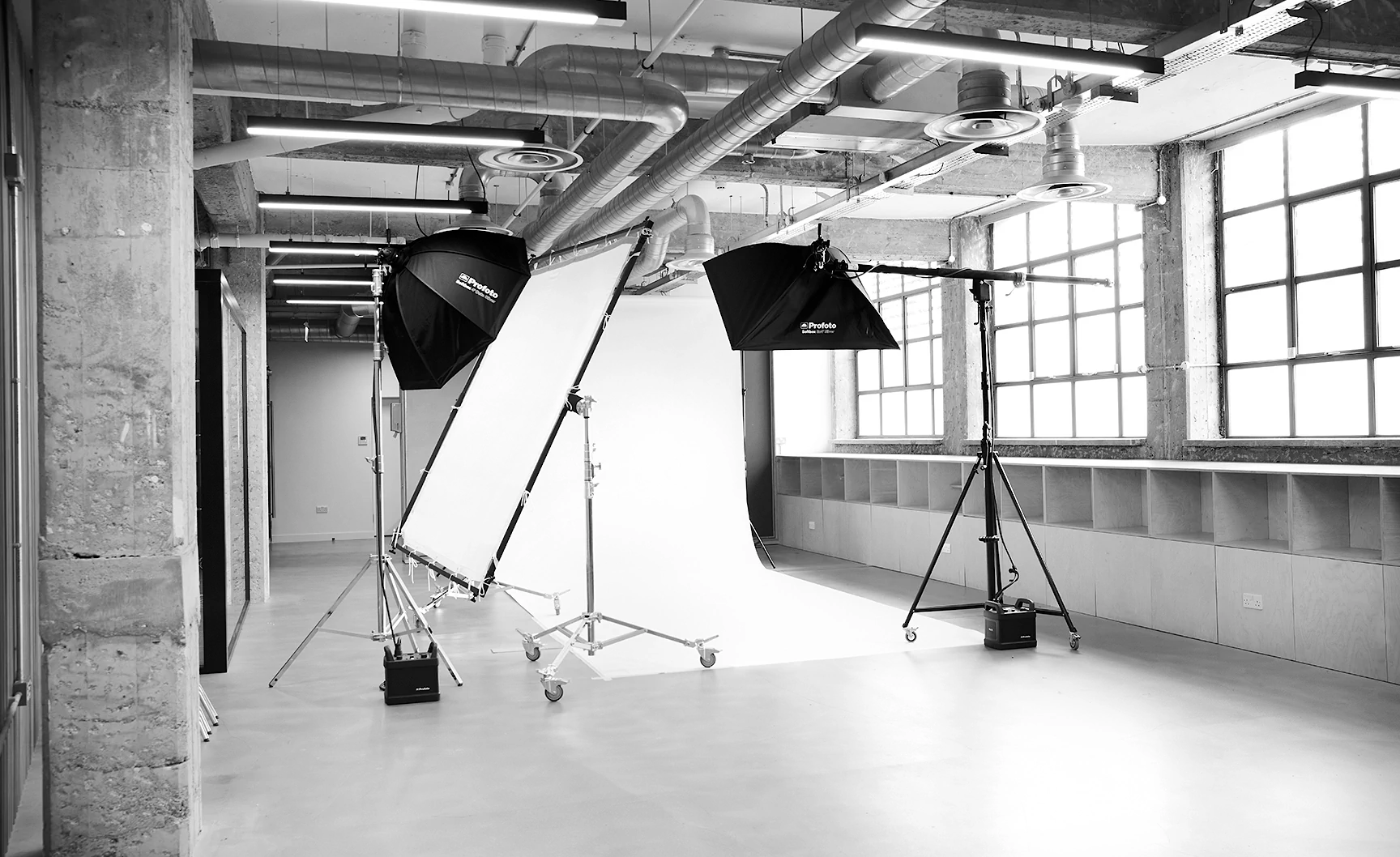 LRP e-commerce photography studio studio with large windows, softbox lights, and a white backdrop.