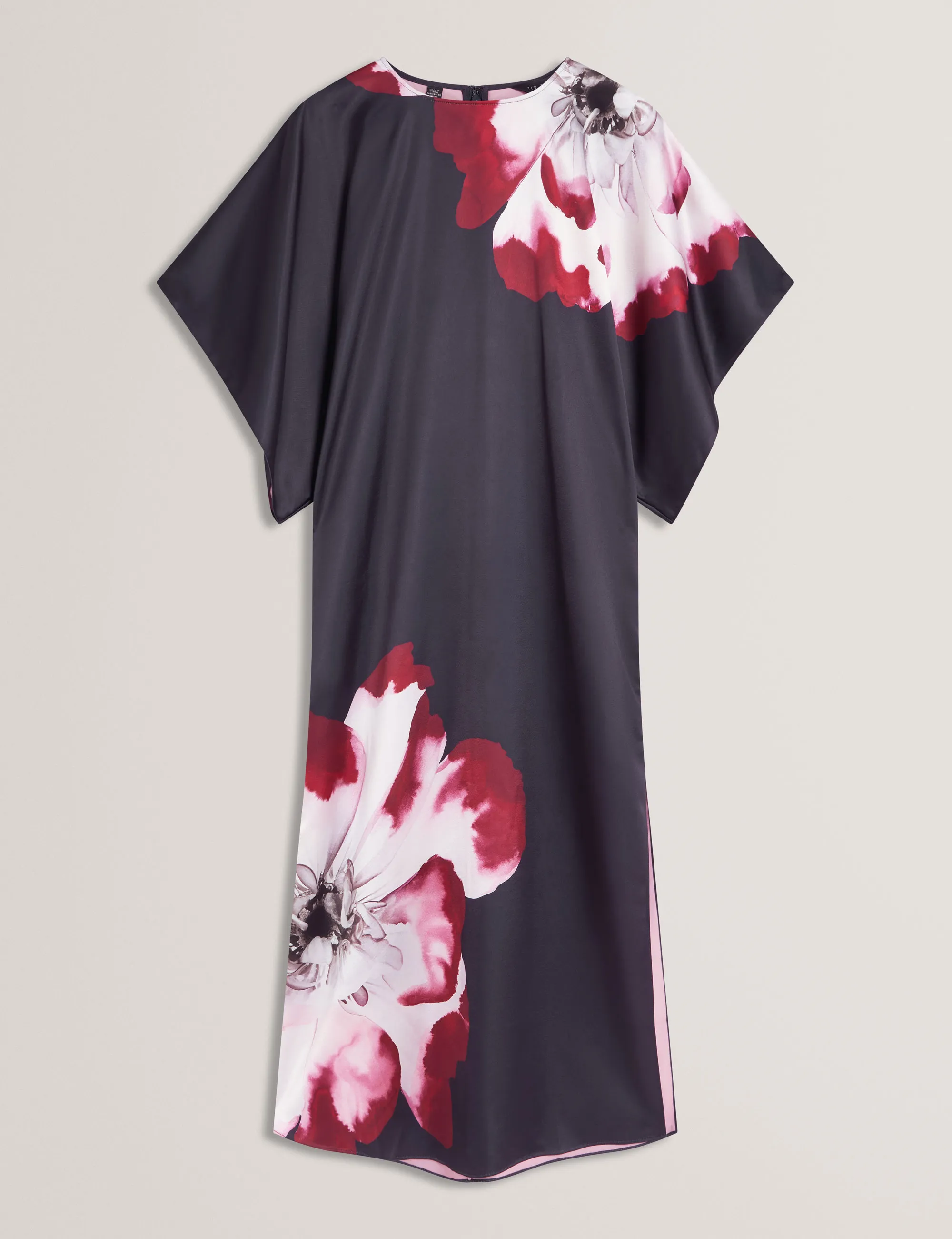 E-commerce product photography of dark navy dress with wide sleeves and large red and white floral prints on shoulder and lower side.