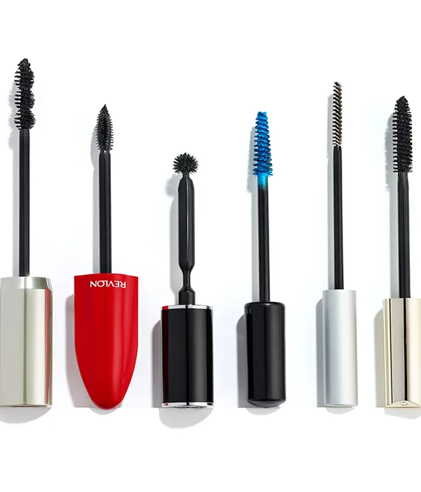 Six different mascara wands with various brush shapes and colors on a white background.