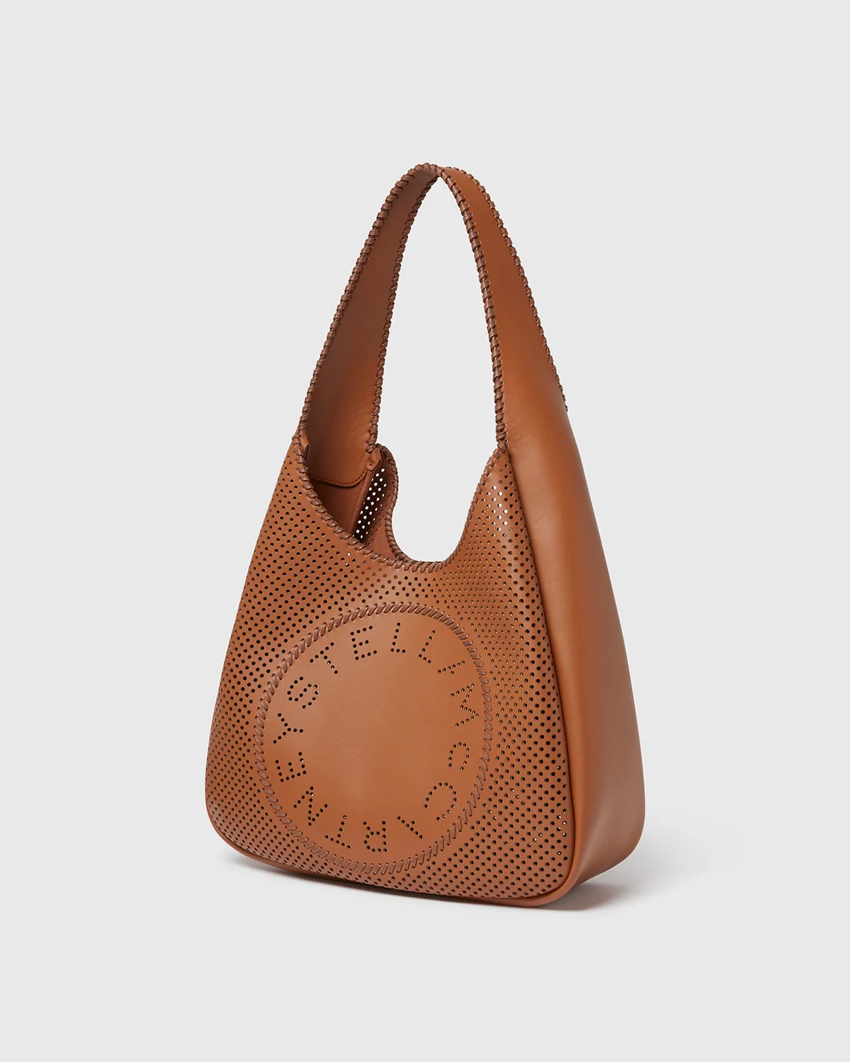 Brown leather bag with perforated holes and circular logo pattern on front.