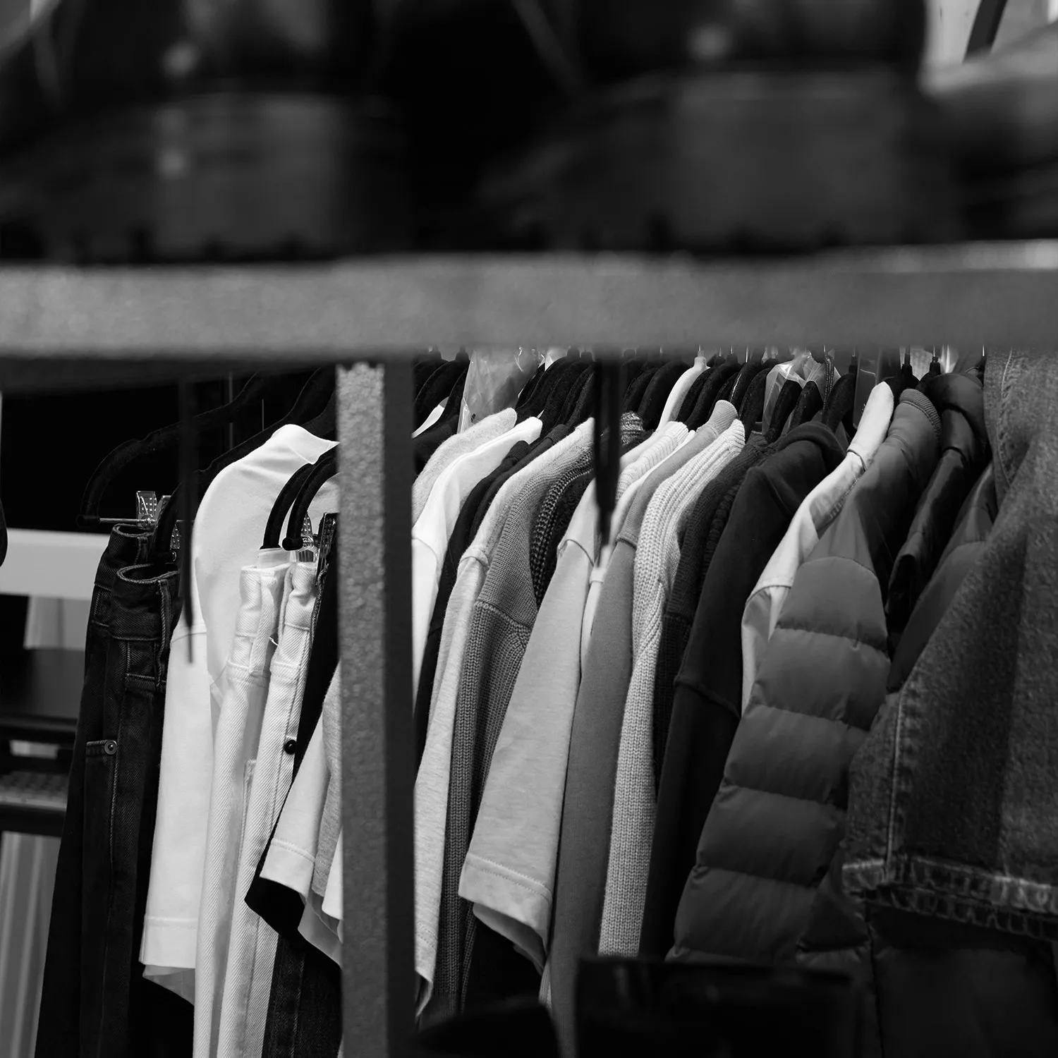 Black and white close-up of a densely packed clothing rack at LRP studios, showing various garments organized and ready for eCommerce photography.