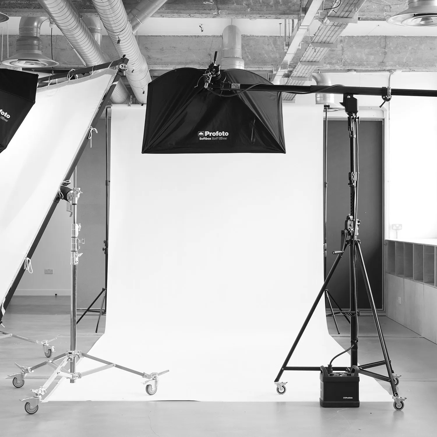 Black and white image of a professional lighting and backdrop setup at LRP studios, featuring Profoto equipment ready for eCommerce photography.
