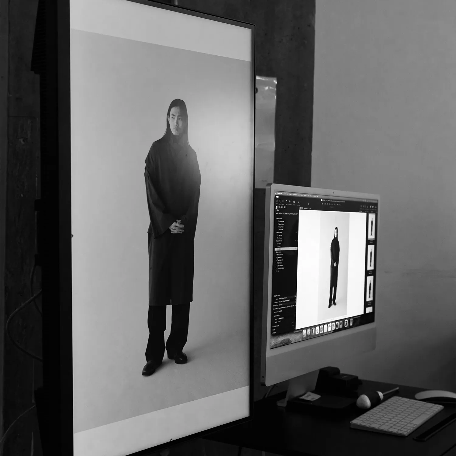Black and white image of a digital tethering and review station at LRP studios, showing monitors displaying a model during an eCommerce photography shoot.