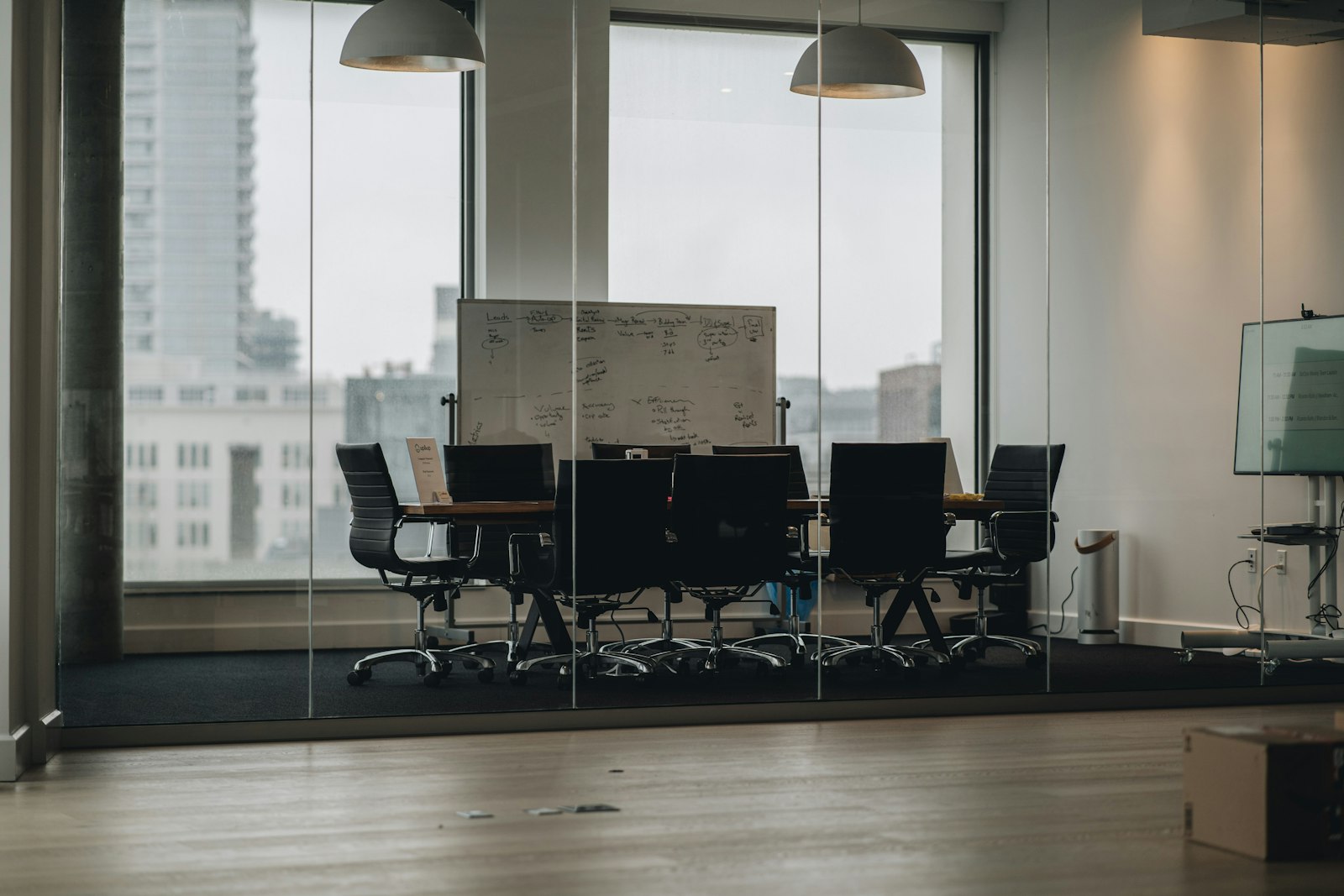 Glass-walled meeting room prepared for an inspection debrief