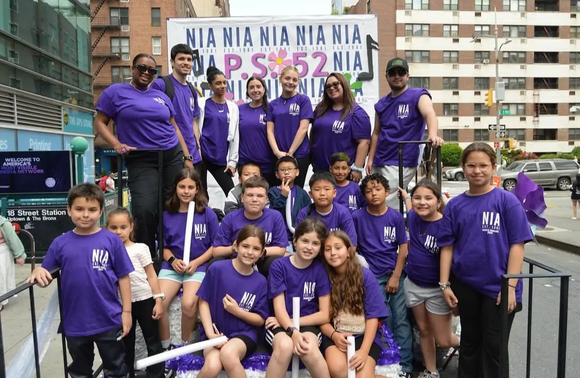 PS 52 NIA students and staff at an outdoor parade event