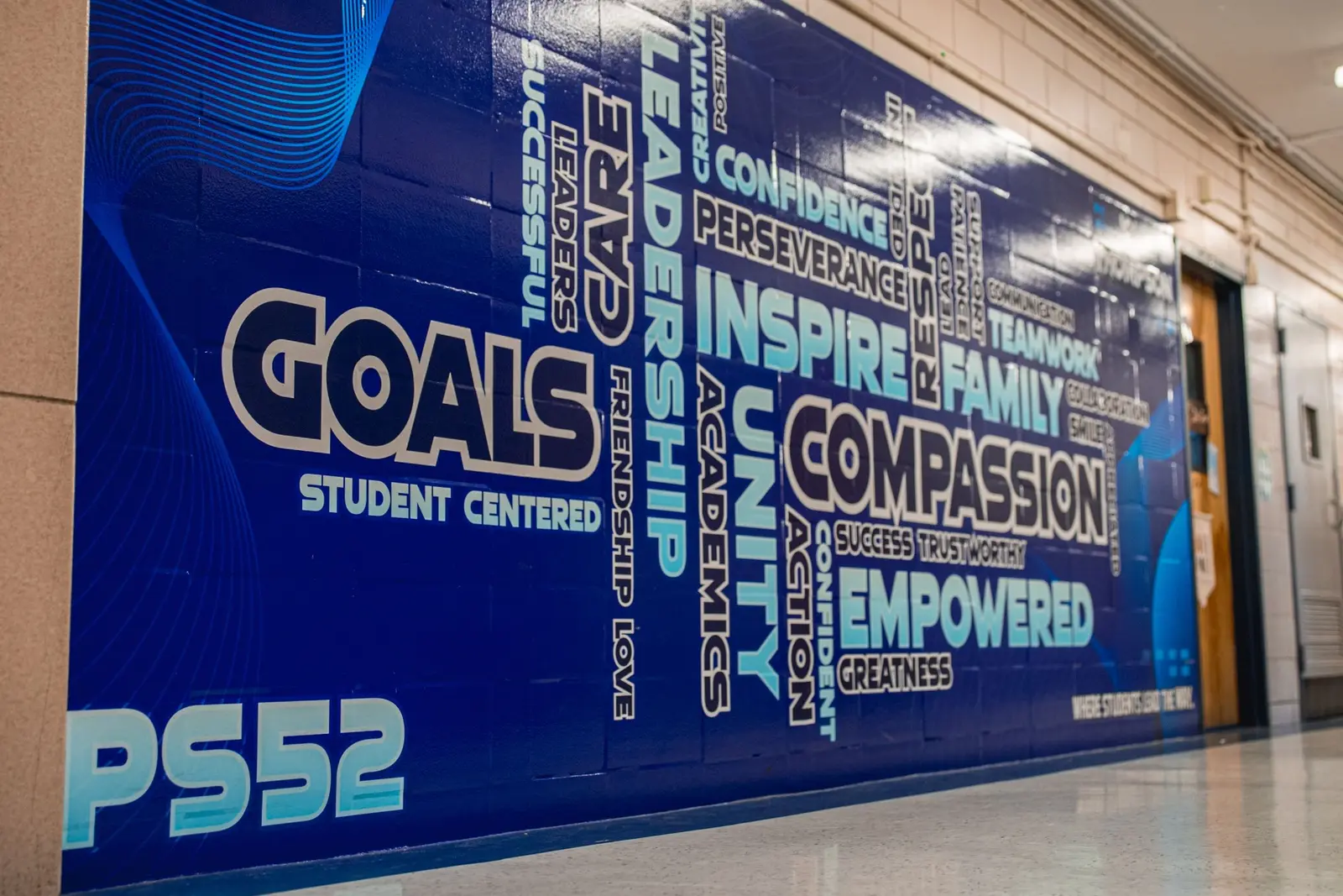 PS52 hallway mural displaying student-centered values and goals