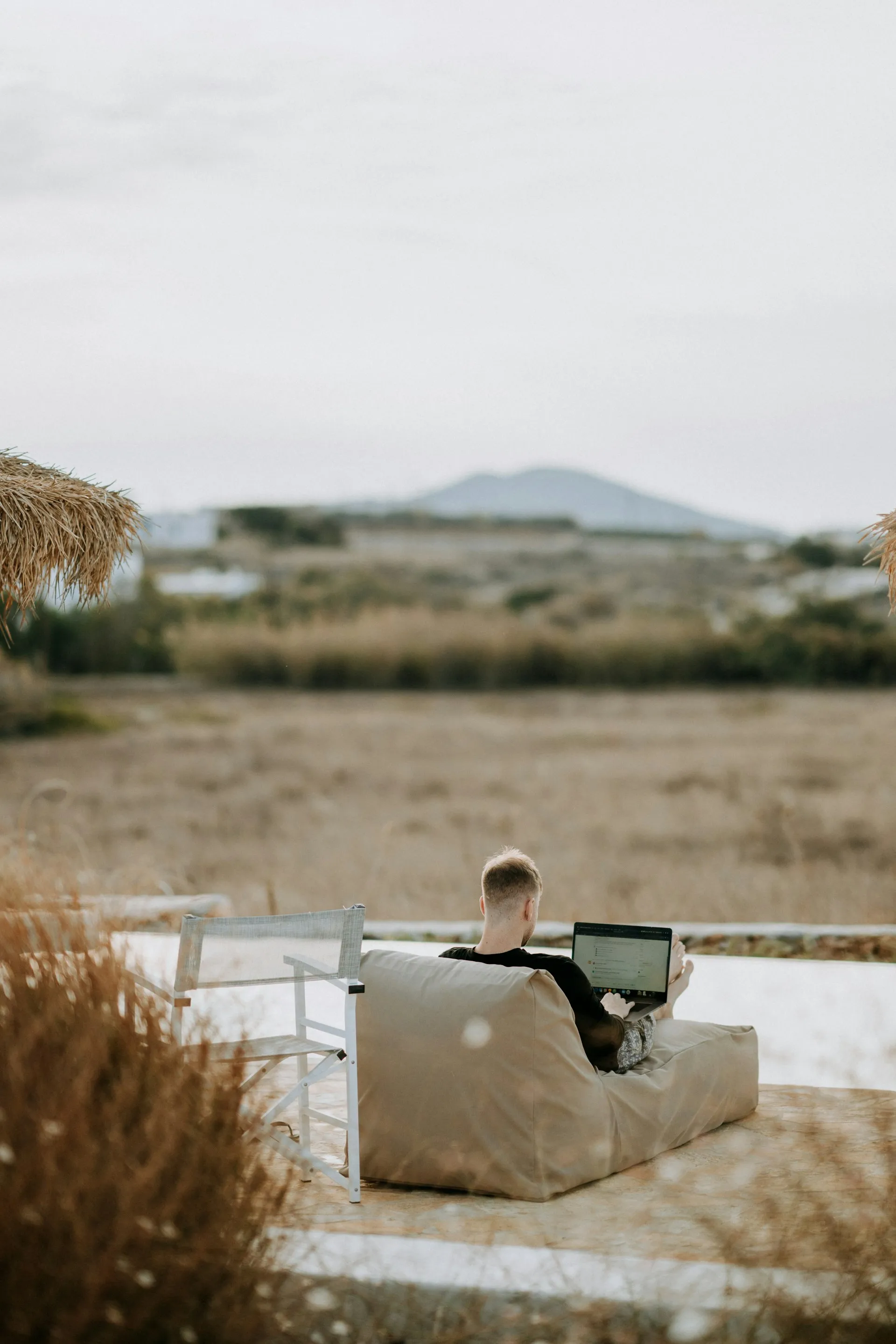 A person working from a laptop outdoors, representing the flexible lifestyle that financial independence can enable.