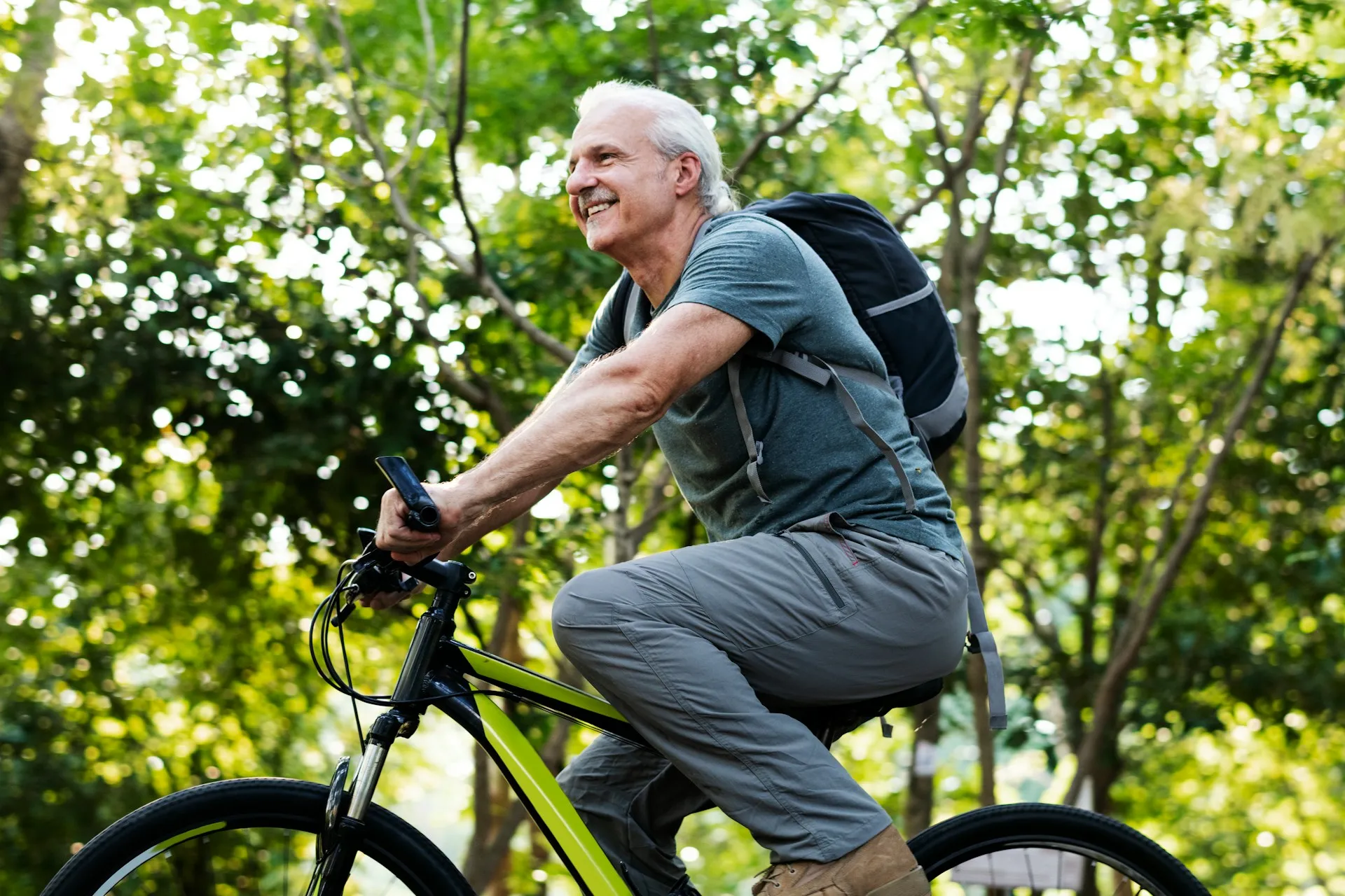 A man riding a bike outdoors, representing an active and fulfilling retirement lifestyle.