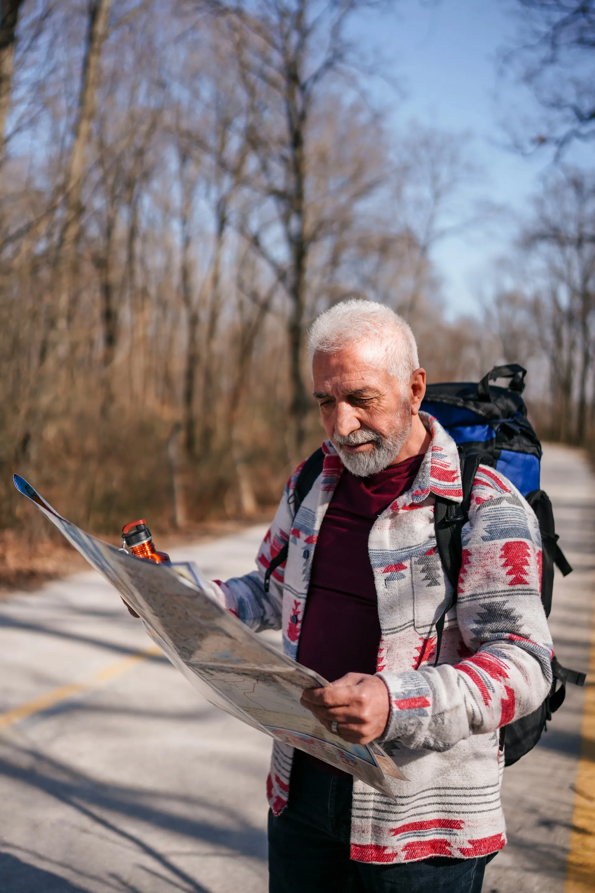 A man navigating with a map outdoors, representing the guided, step-by-step approach Sears Group takes with each client's financial journey.