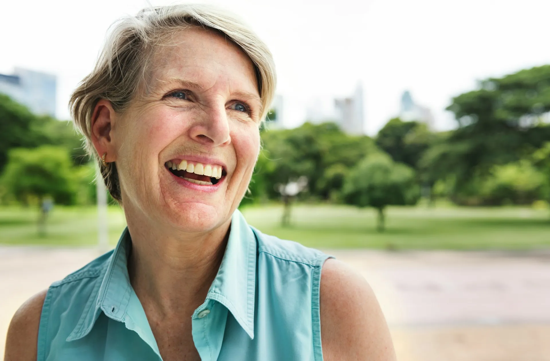 A woman smiling warmly, representing the approachable and client-centered experience at Sears Group.