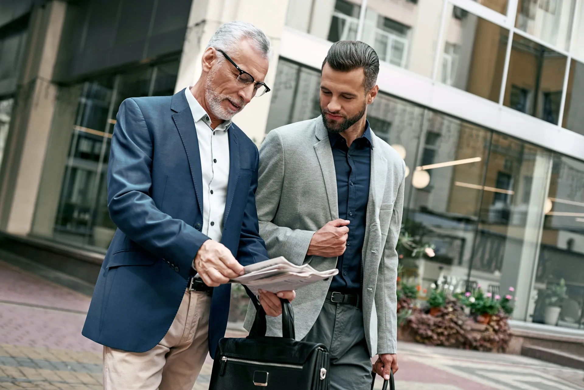 A father and son working together in a family business, representing the multi-generational business clients Sears Group serves.