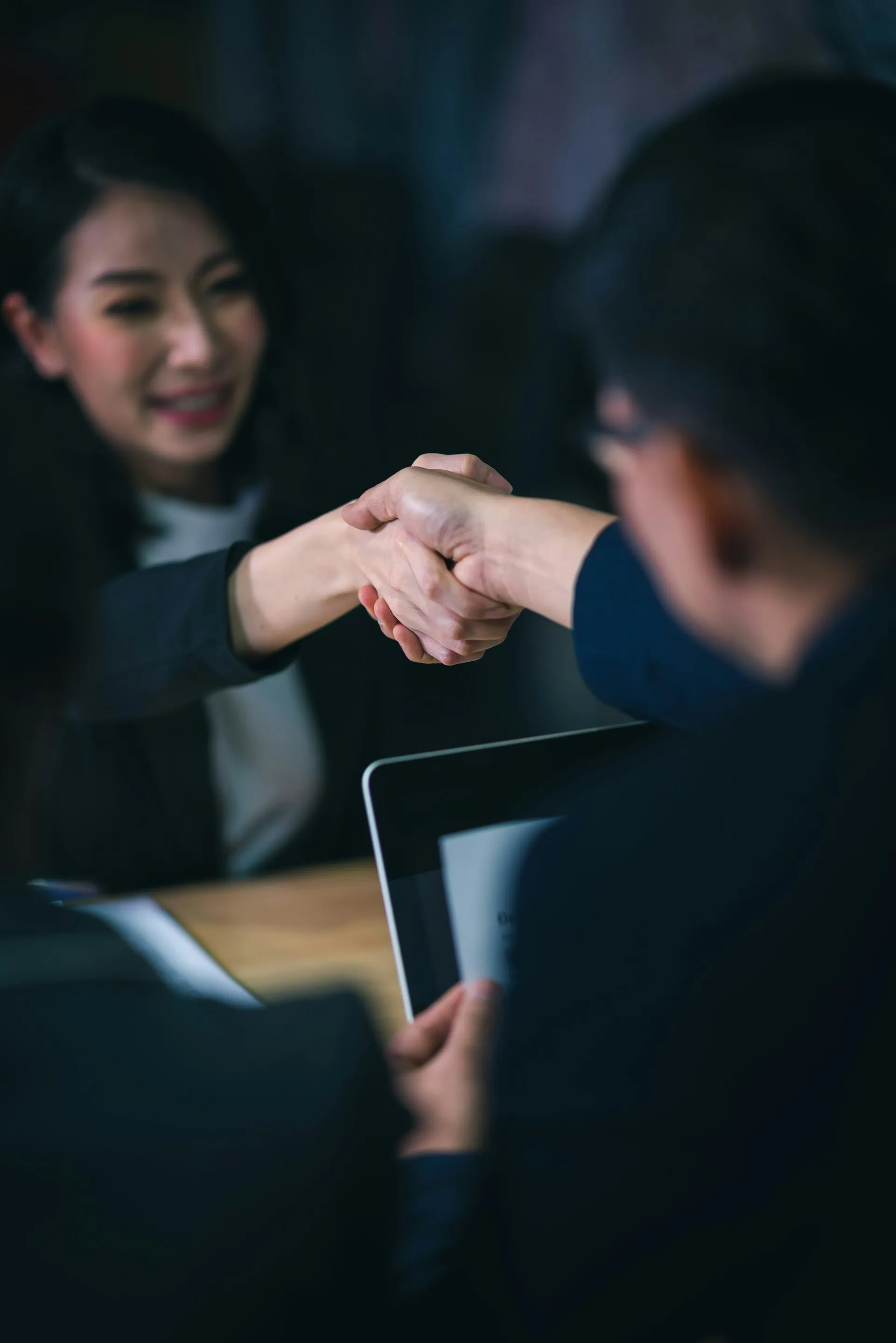 Two professionals shaking hands to close a deal, representing the trusted advisor relationship at Sears Group.