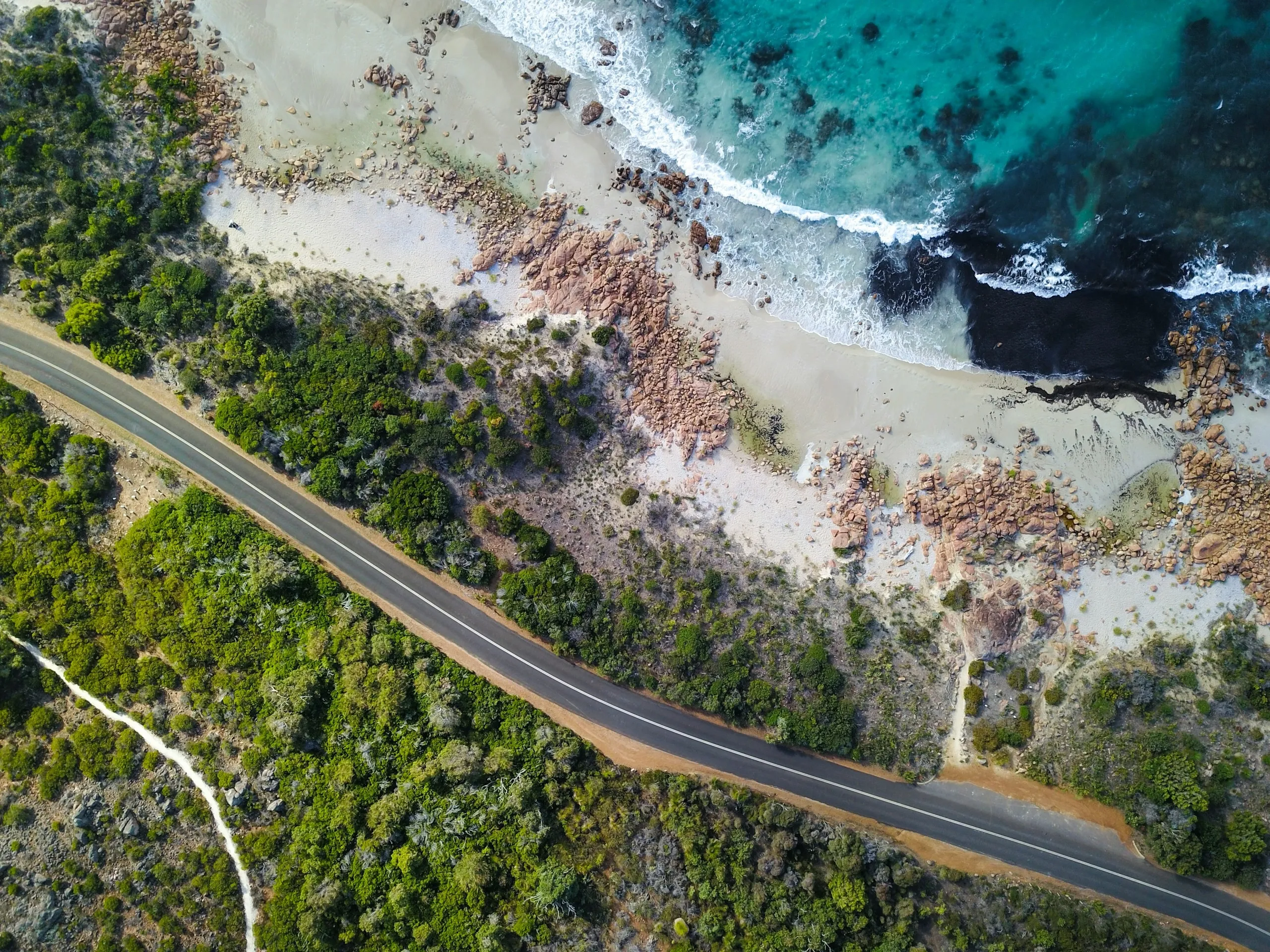 A scenic coastal road stretching into the distance, representing the journey toward long-term financial goals.