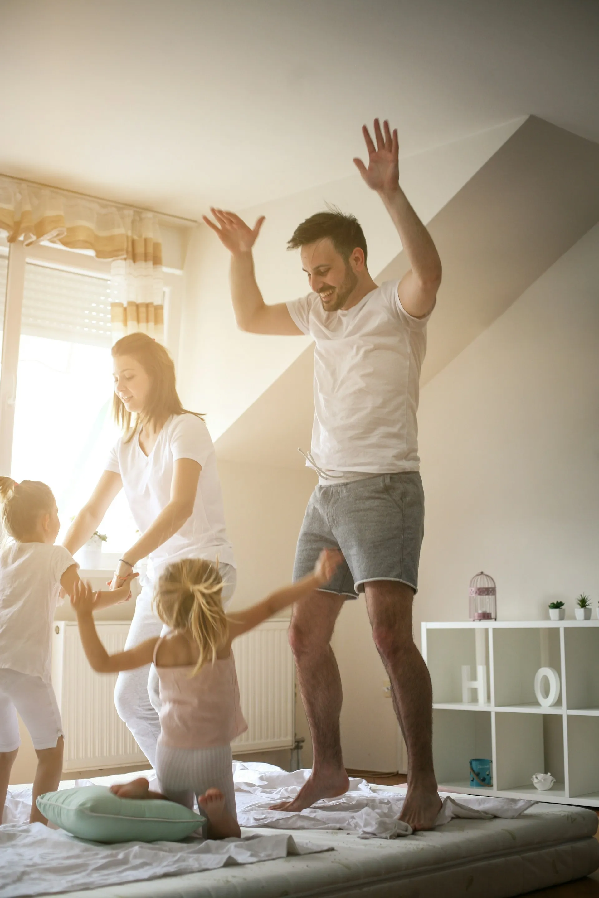 A family jumping joyfully together outdoors, representing the happiness and security a strong financial plan can provide.