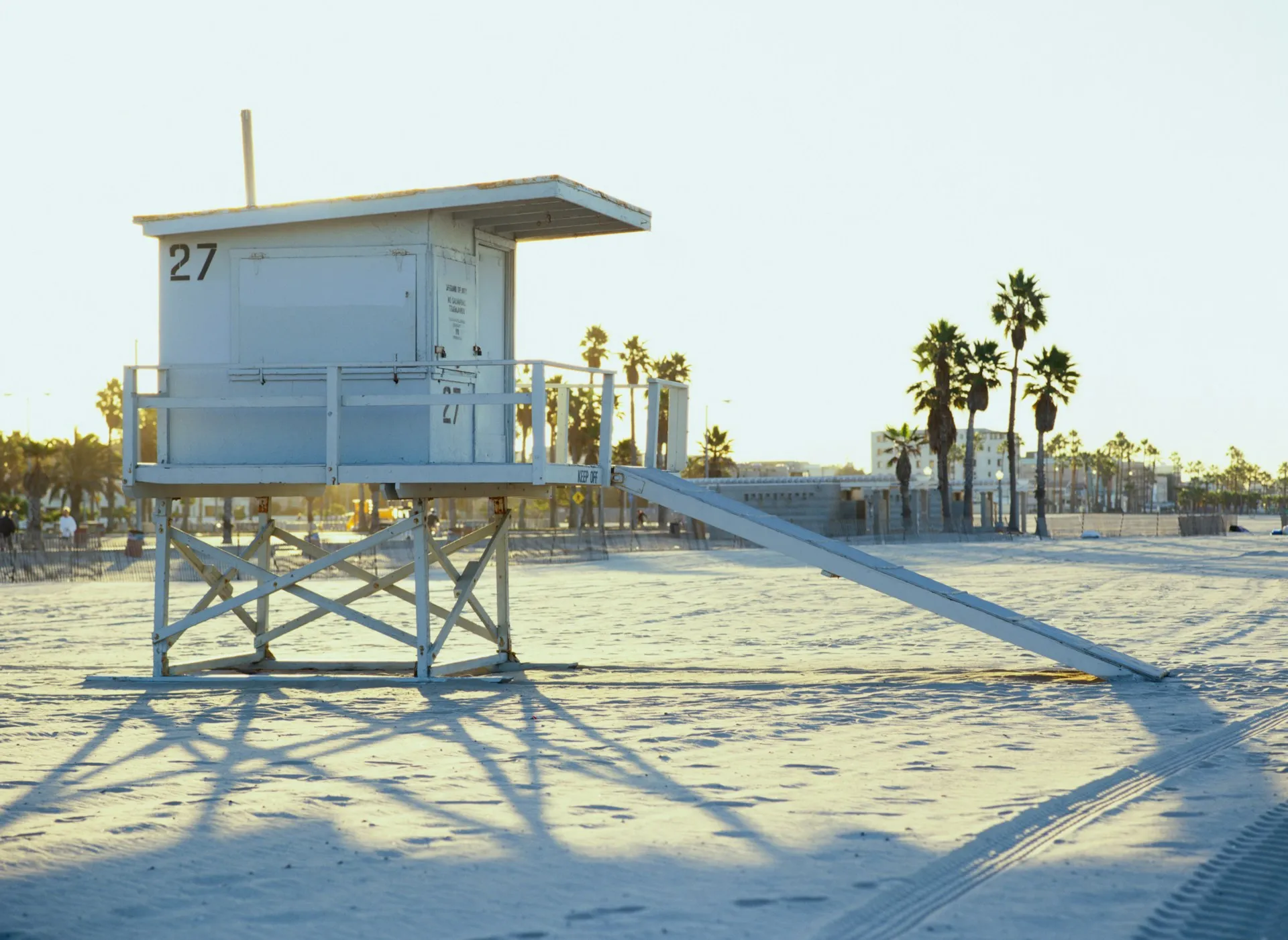 A lifeguard station on a sunny beach, symbolizing protection, watchfulness, and security for your financial future.