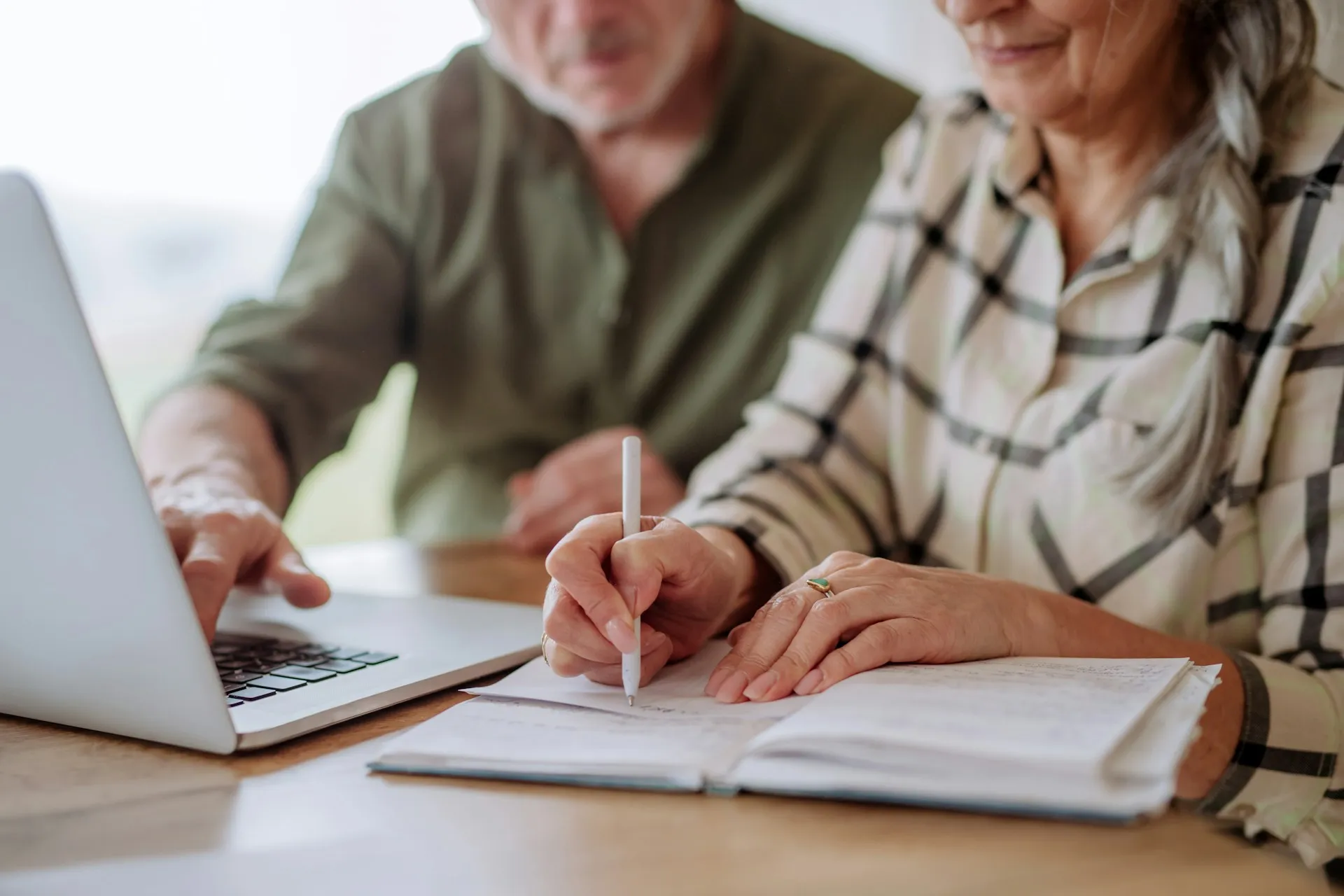 A person reviewing financial documents at a desk, representing the detailed work behind comprehensive financial planning.