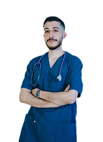 Male healthcare professional in blue scrubs with stethoscope, arms crossed, and confident expression.
