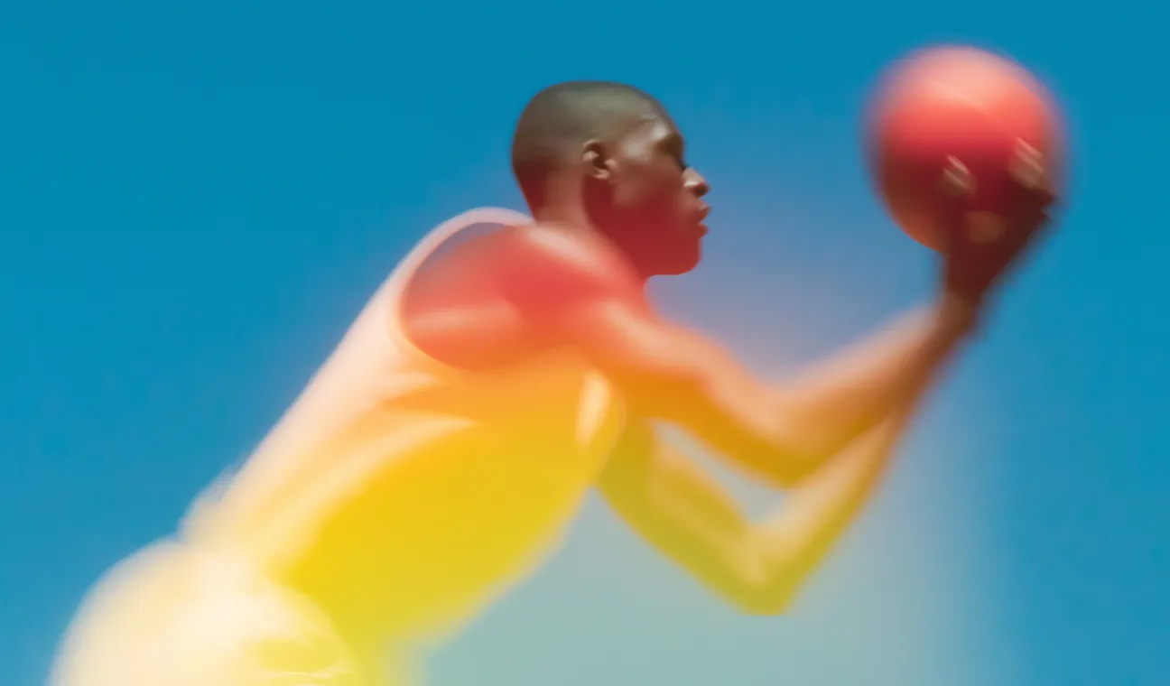 Person throwing an orange ball against a blue background