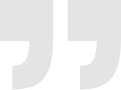 Gray quotation mark icon on a light background