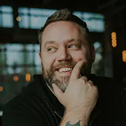 Portrait of a bearded man touching his chin thoughtfully