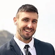 Portrait of a smiling bearded man in a suit