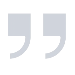 Gray quotation mark icon on a dark background