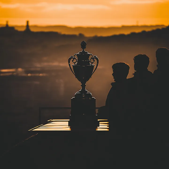 Silhouettes of people at sunset holding an open book