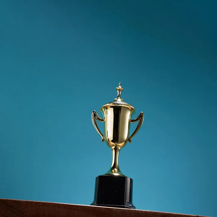 Gold trophy cup against a blue background