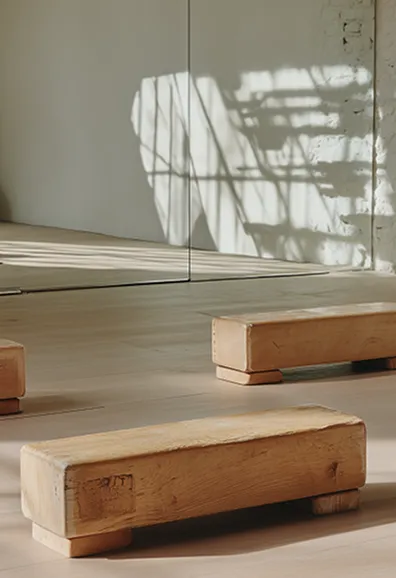 Stack of wooden blocks with soft shadows on a white surface