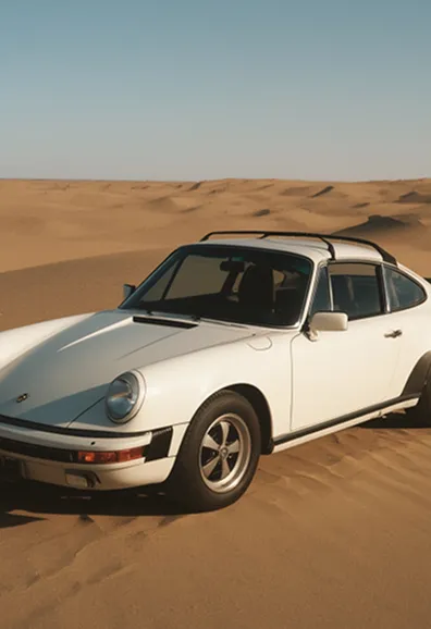 Classic white sports car parked on a dirt road